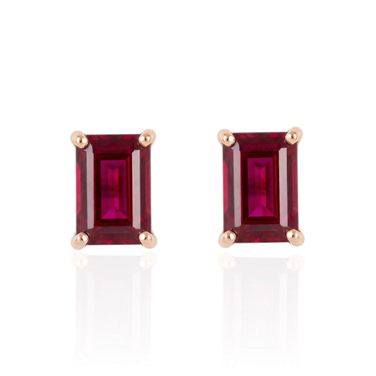 Pair of rectangular ruby stud earrings set in rose gold plated sterling silver front on white background