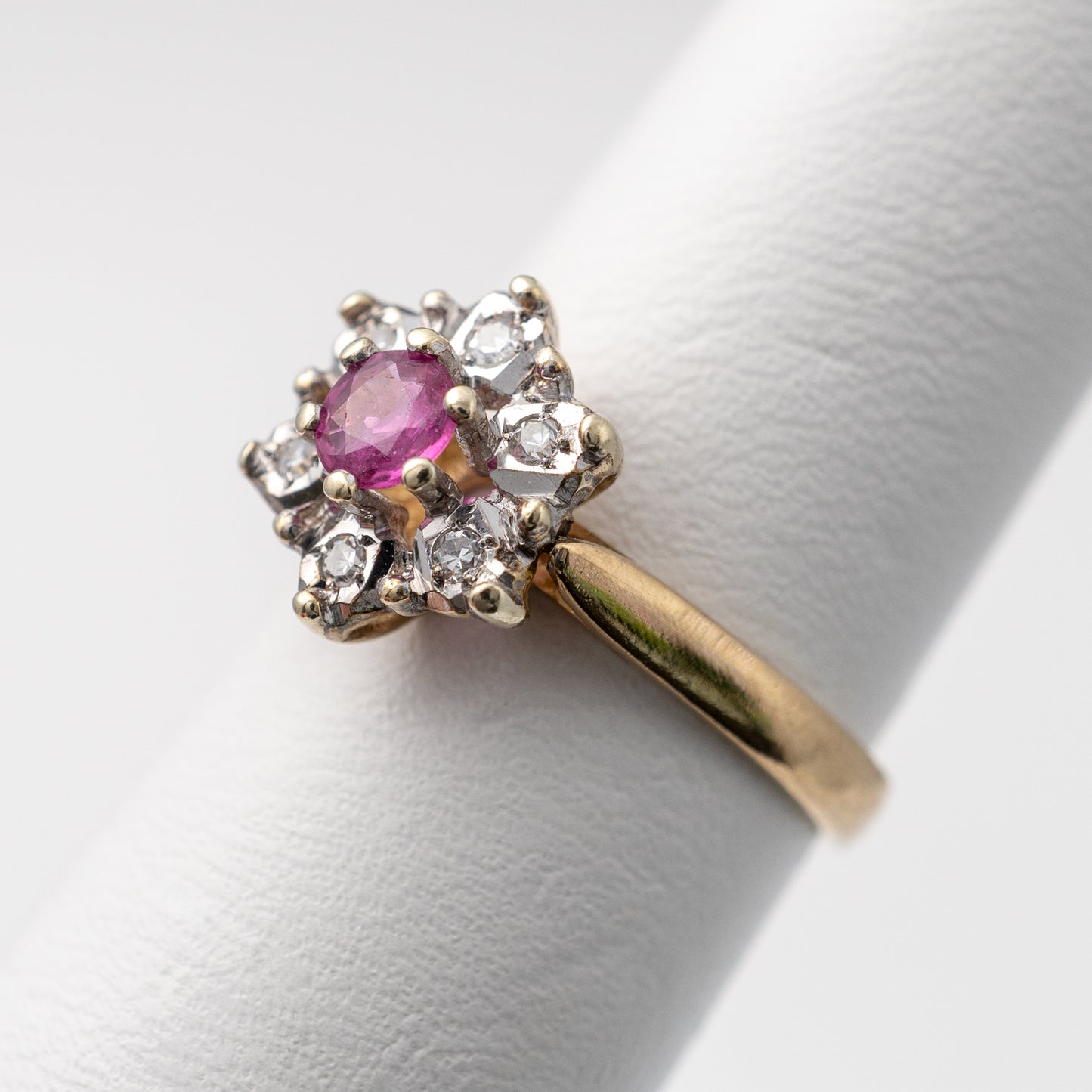 Side view of ruby engagement ring with diamond halo in 9ct yellow gold