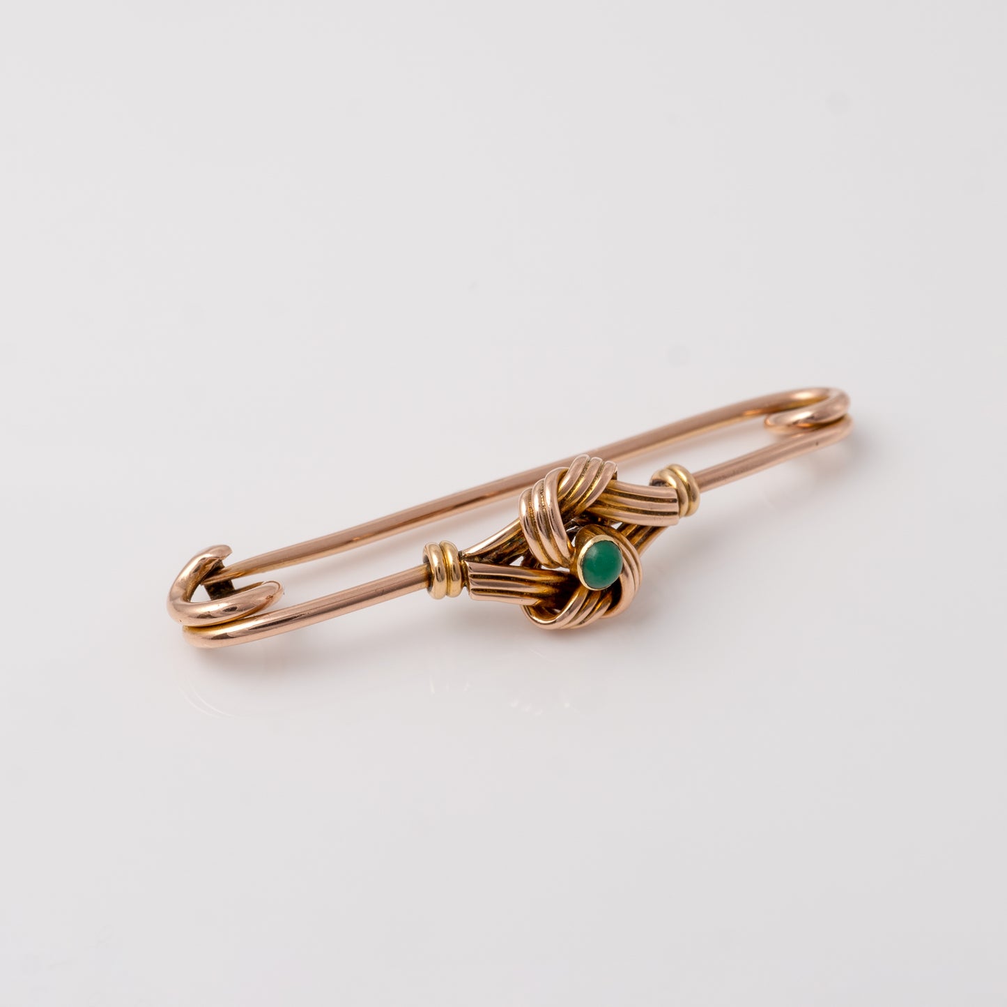 side view of the antique gold brooch with turquoise, emphasising the smooth curve of the pin and the detailed gold work around the gemstone - Hunters Fine Jewellery