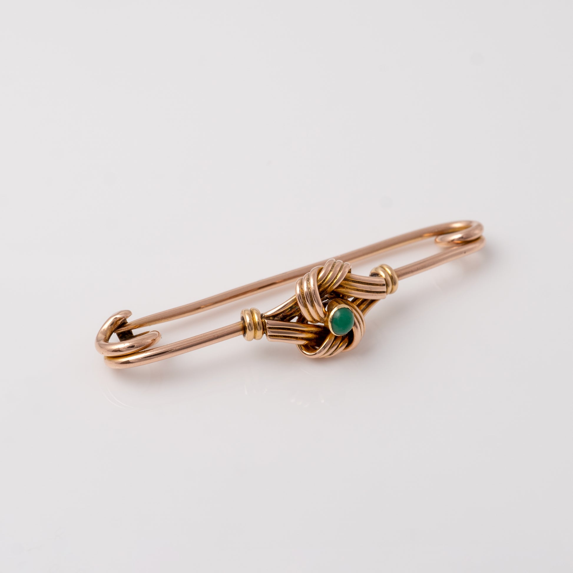 side view of the antique gold brooch with turquoise, emphasising the smooth curve of the pin and the detailed gold work around the gemstone - Hunters Fine Jewellery