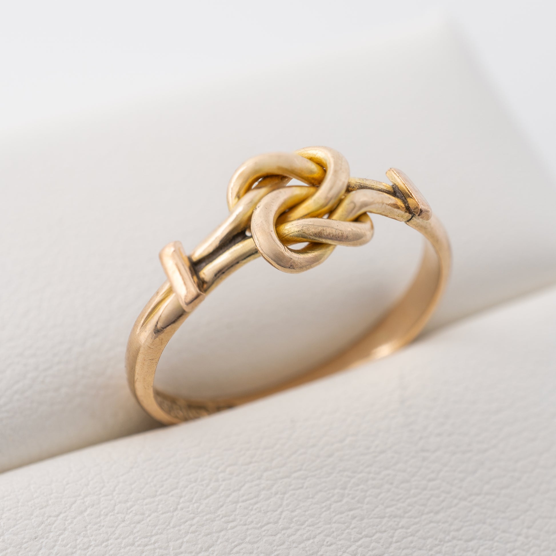 Side view of antique gold knot ring showing the knot detail and band