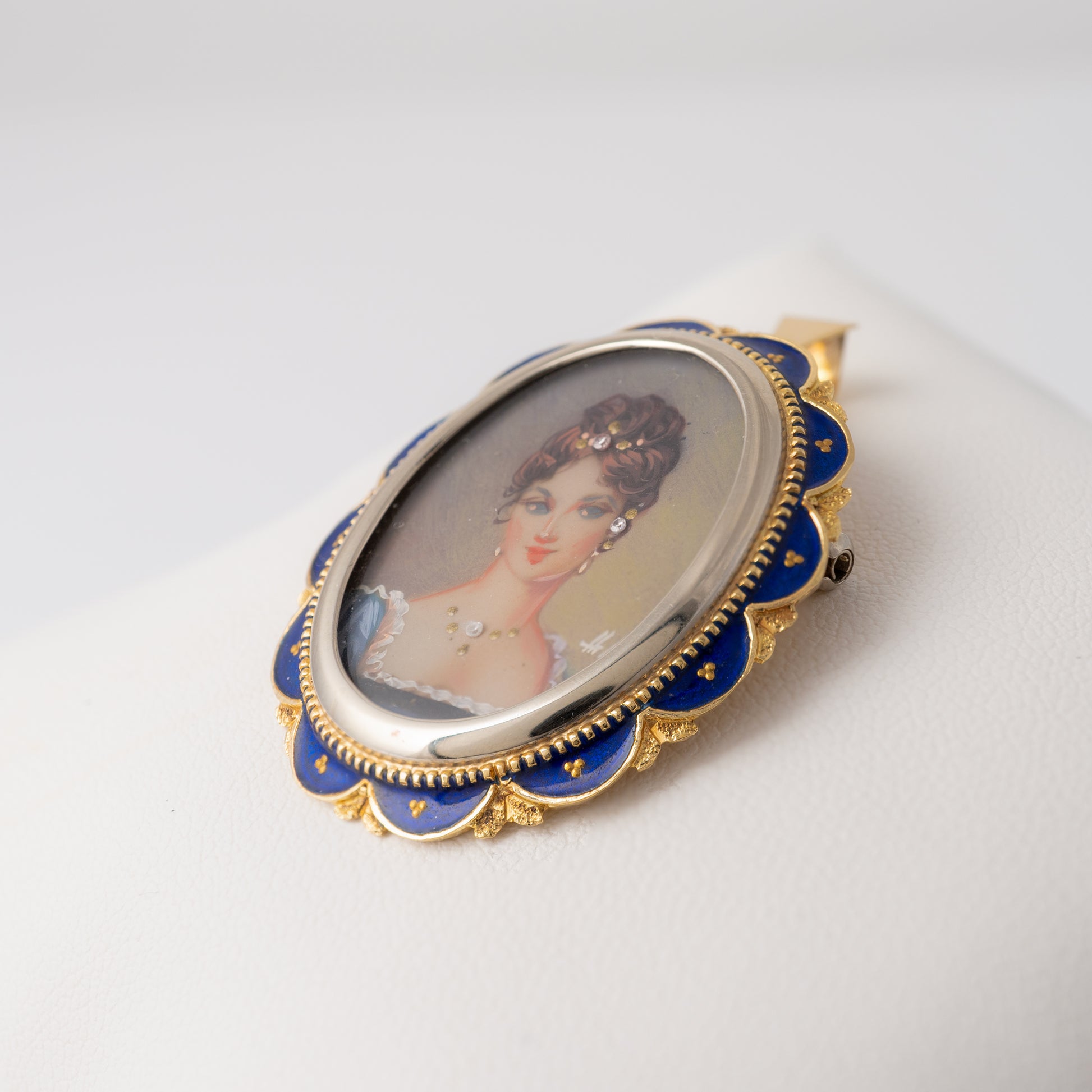 Side profile of vintage enamel portrait pendant brooch in 18k gold