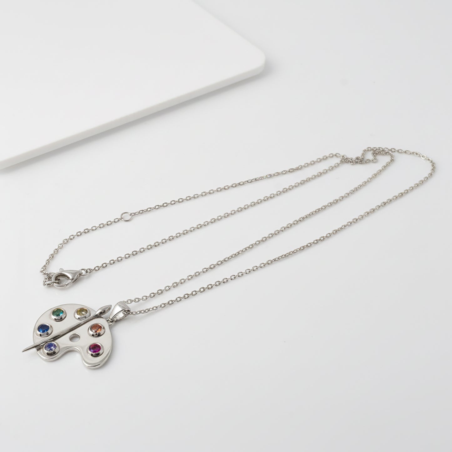 Silver Artist Palette Necklace with a colorful pendant on a white background