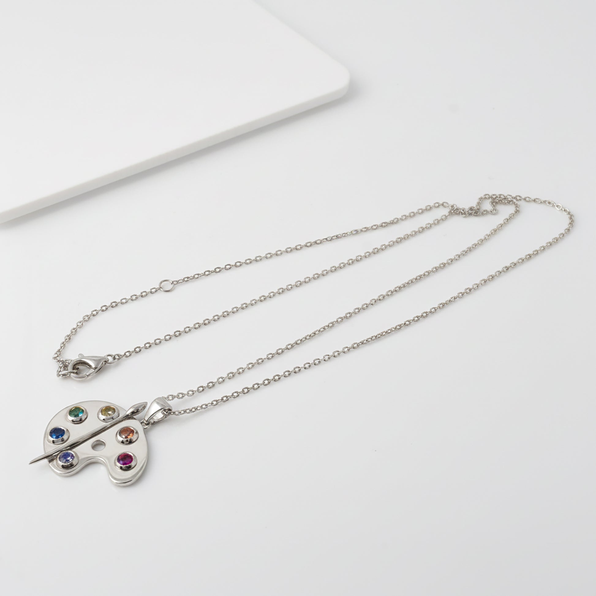 Silver Artist Palette Necklace with a colorful pendant on a white background