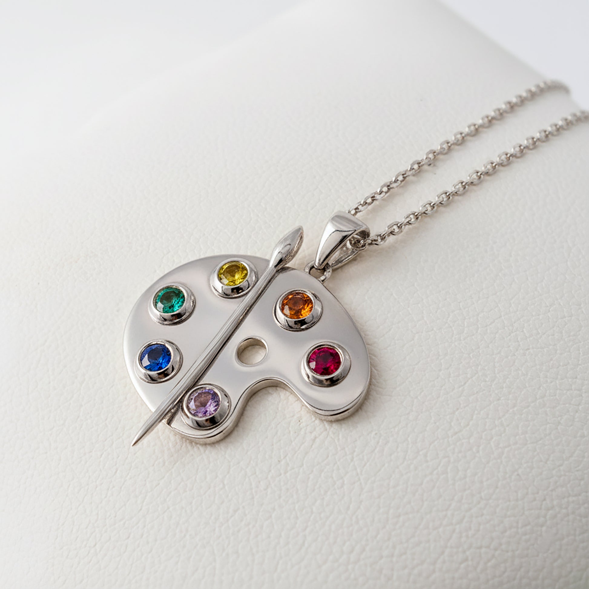 silver artist palette pendant with rainbow gemstones side view