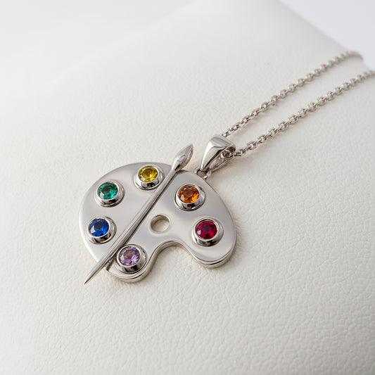silver artist palette pendant with rainbow gemstones side view