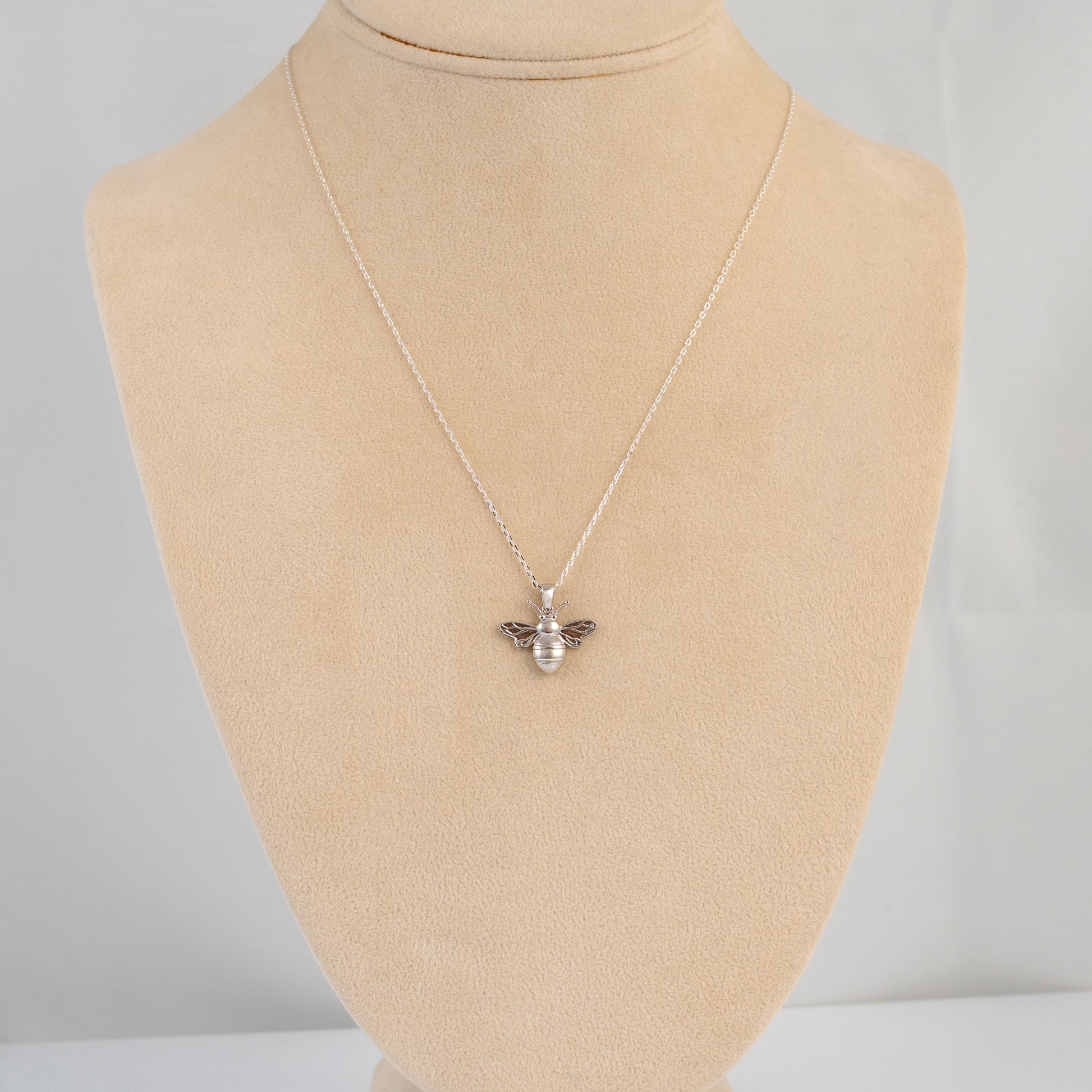 Silver bee necklace shown on mannequin bust display