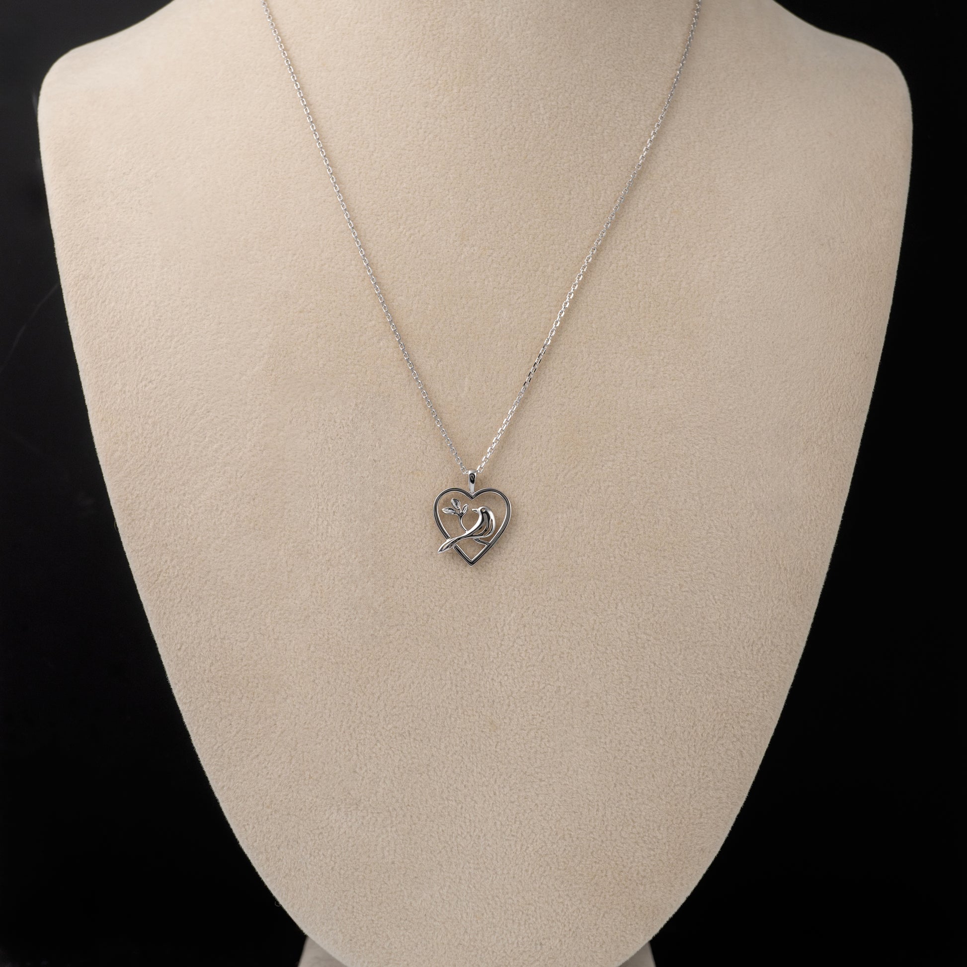 Sterling silver bird heart pendant necklace worn on mannequin bust