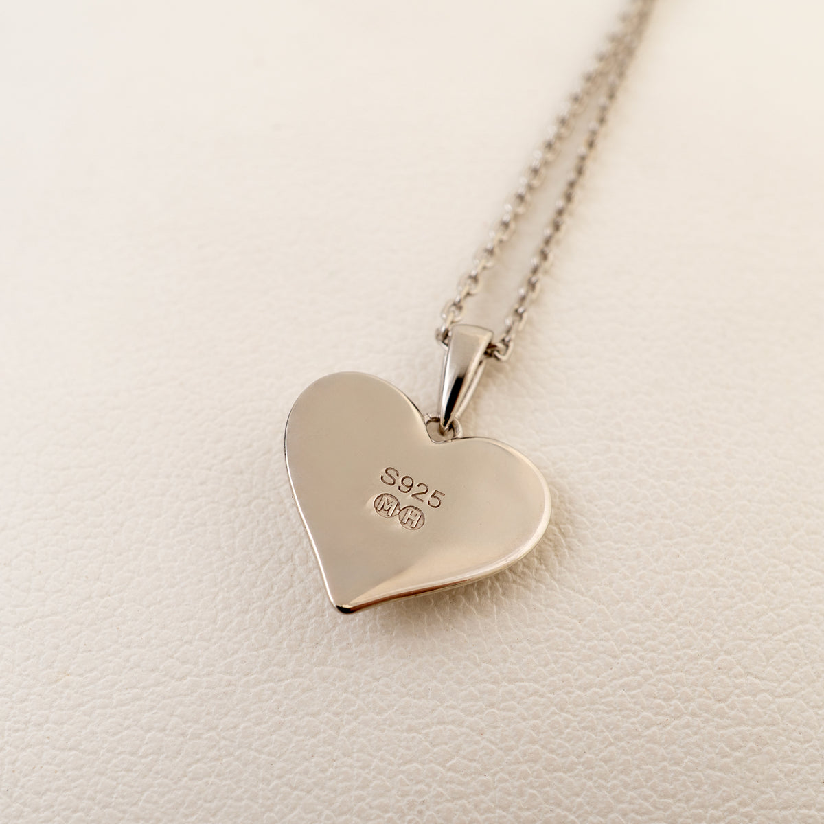 Flat reverse of the sterling silver heart pendant showing the 925 and Michael Hunter maker’s marks.