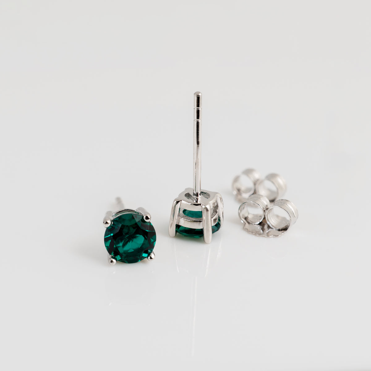 Sterling silver lab emerald stud earrings showing posts and butterfly backs