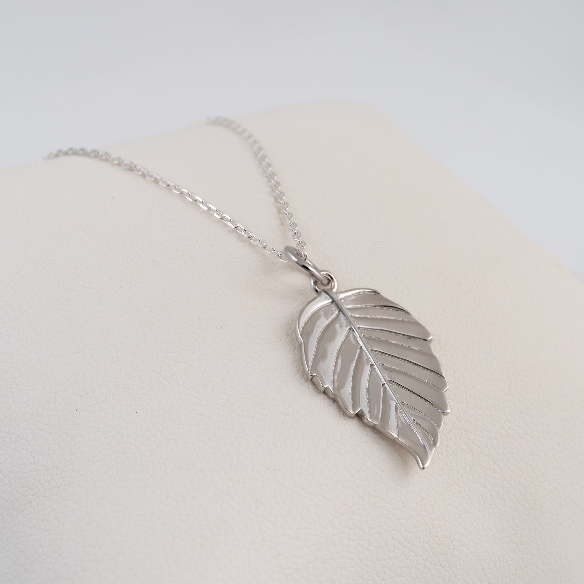 Silver leaf necklace on a light background