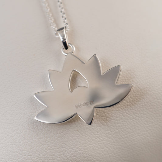 Back view of sterling silver lotus flower pendant showing smooth hallmark surface