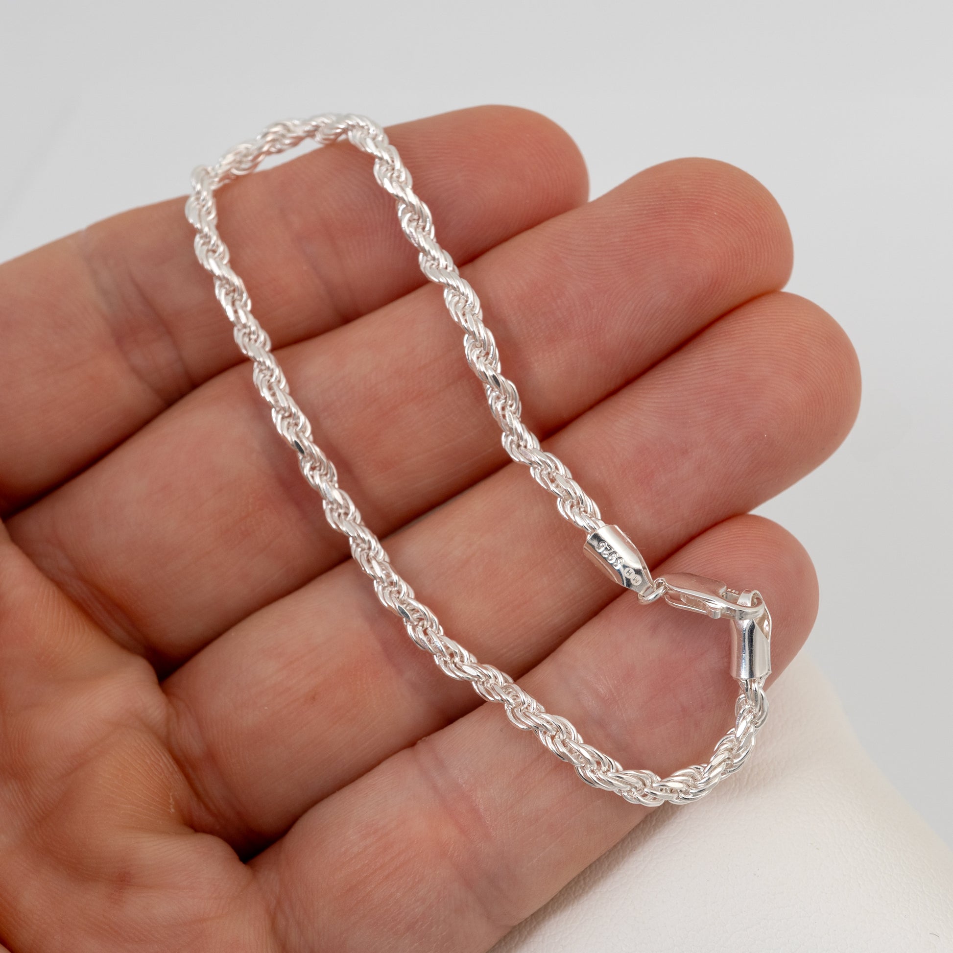3mm silver rope bracelet being held to show size and shine