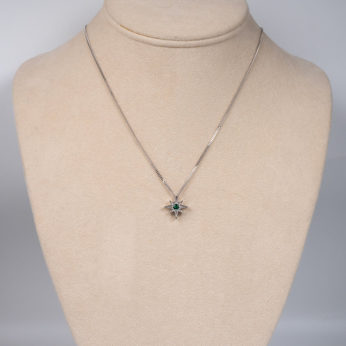 silver celestial necklace displayed on bust stand