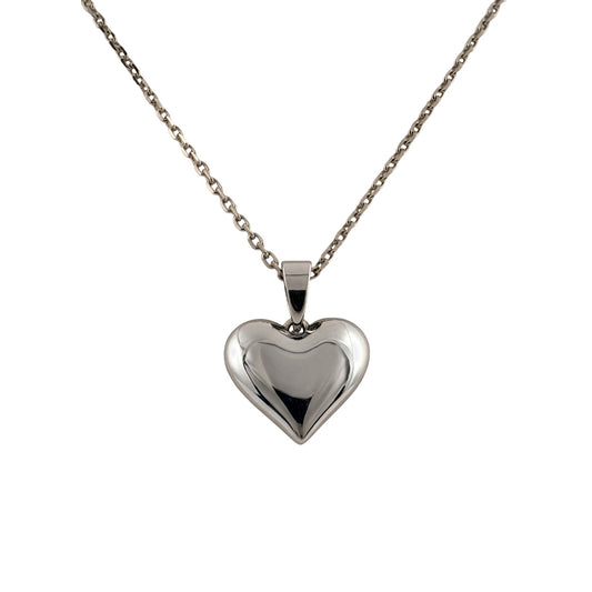 A polished silver heart-shaped pendant necklace on a delicate silver chain, shown against a plain white background.