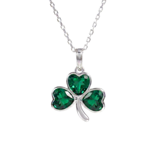 A sterling silver shamrock pendant necklace with three heart-shaped green crystals, shown on a white background.