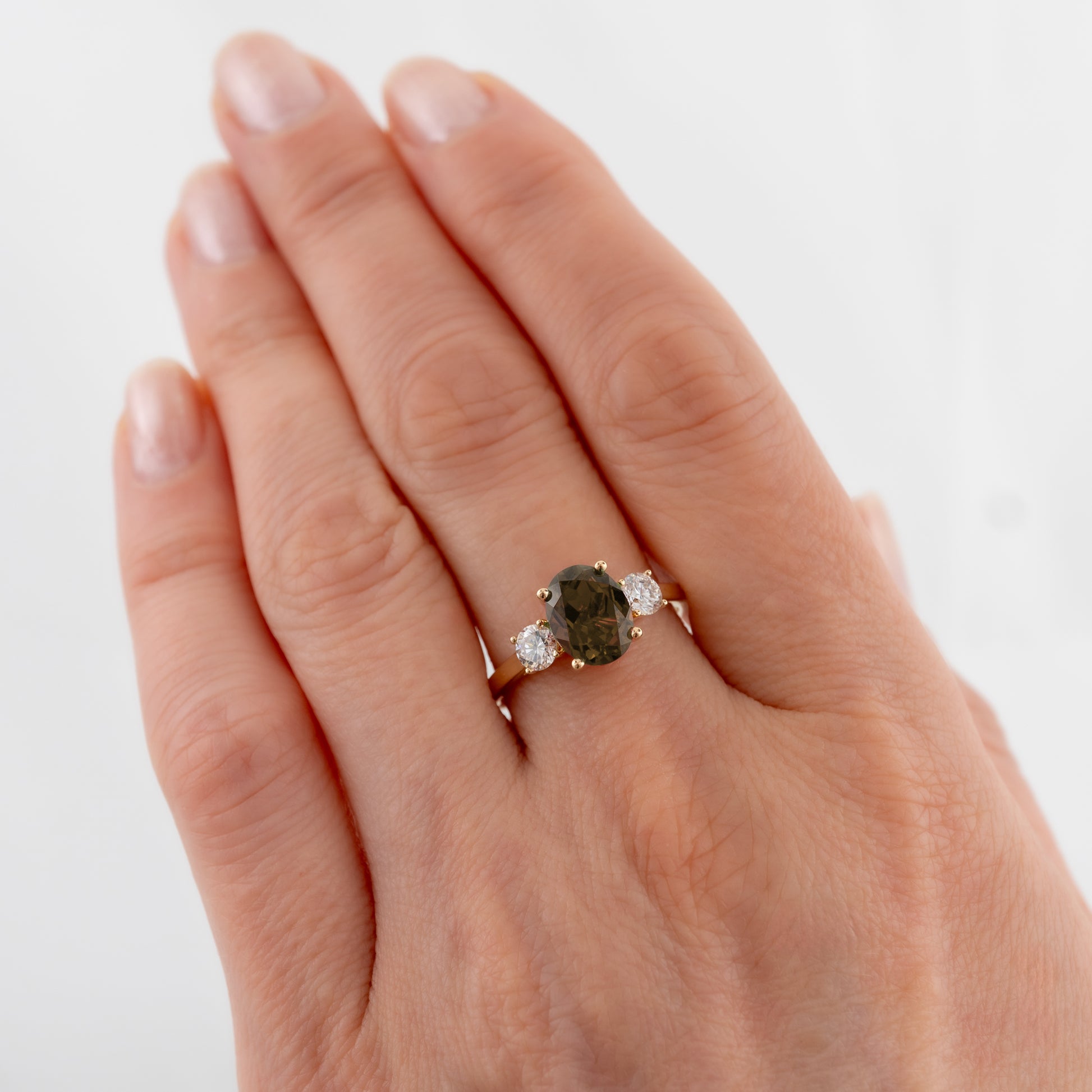 smoky quartz three stone ring womans hand