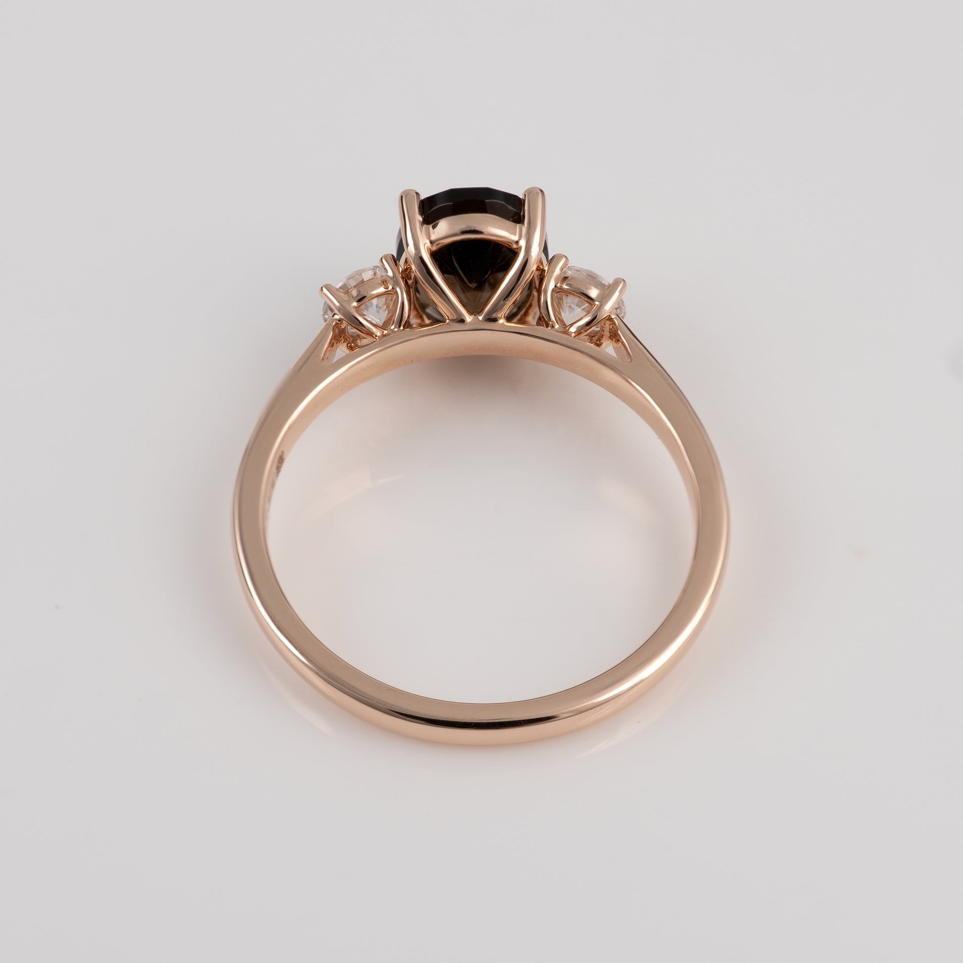 smoky quartz ring with a central gemstone on a light gray background
