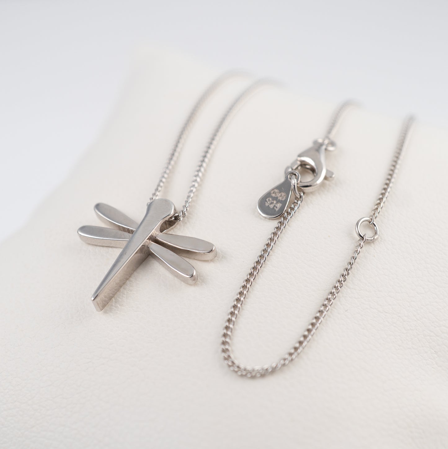 Silver dragonfly pendant necklace with adjustable curb chain on a white background