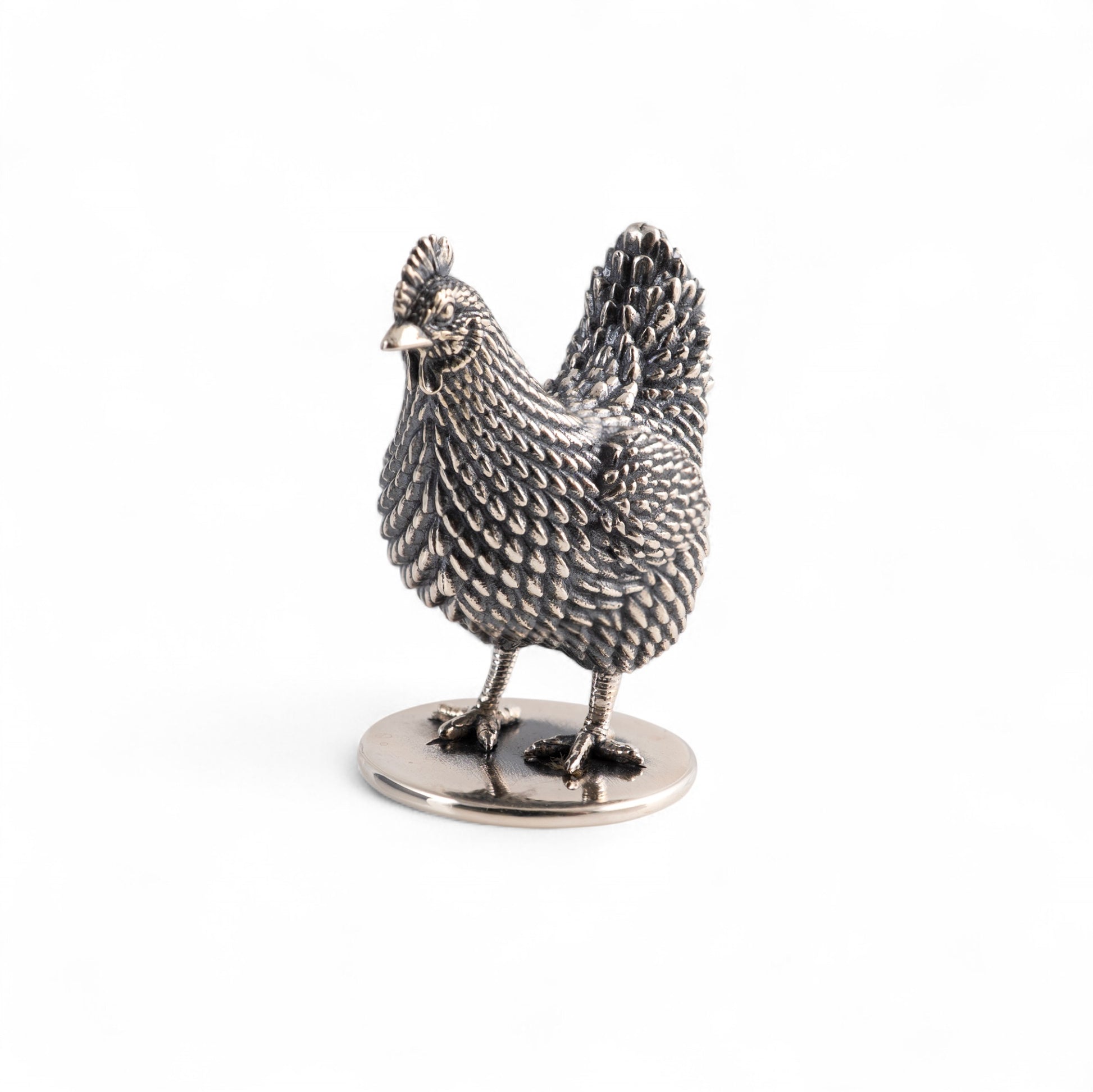Silver chicken figurine on a white background