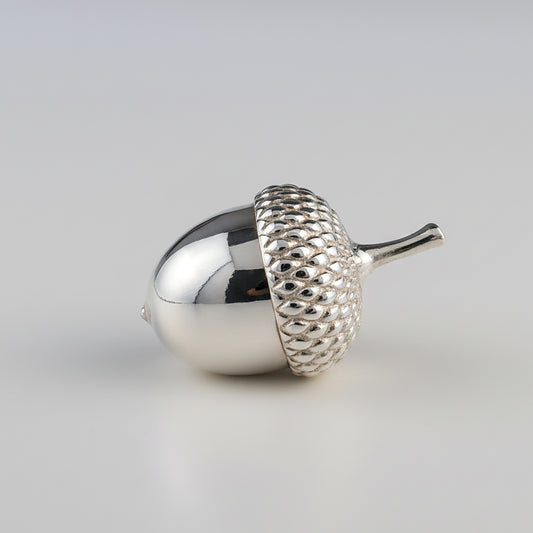 strling Silver acorn-ornament on a light gray background