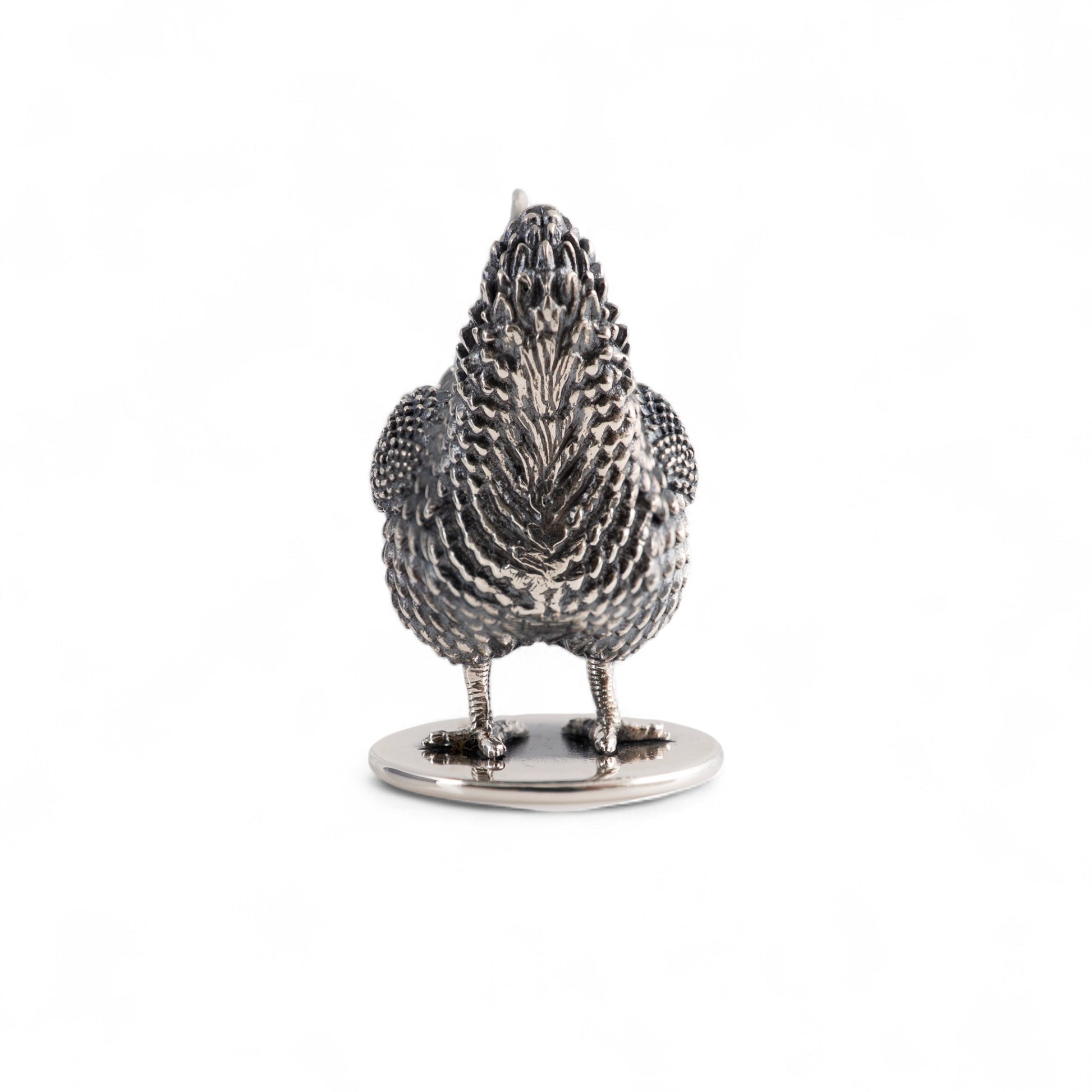 Silver hen figurine back view on a white background