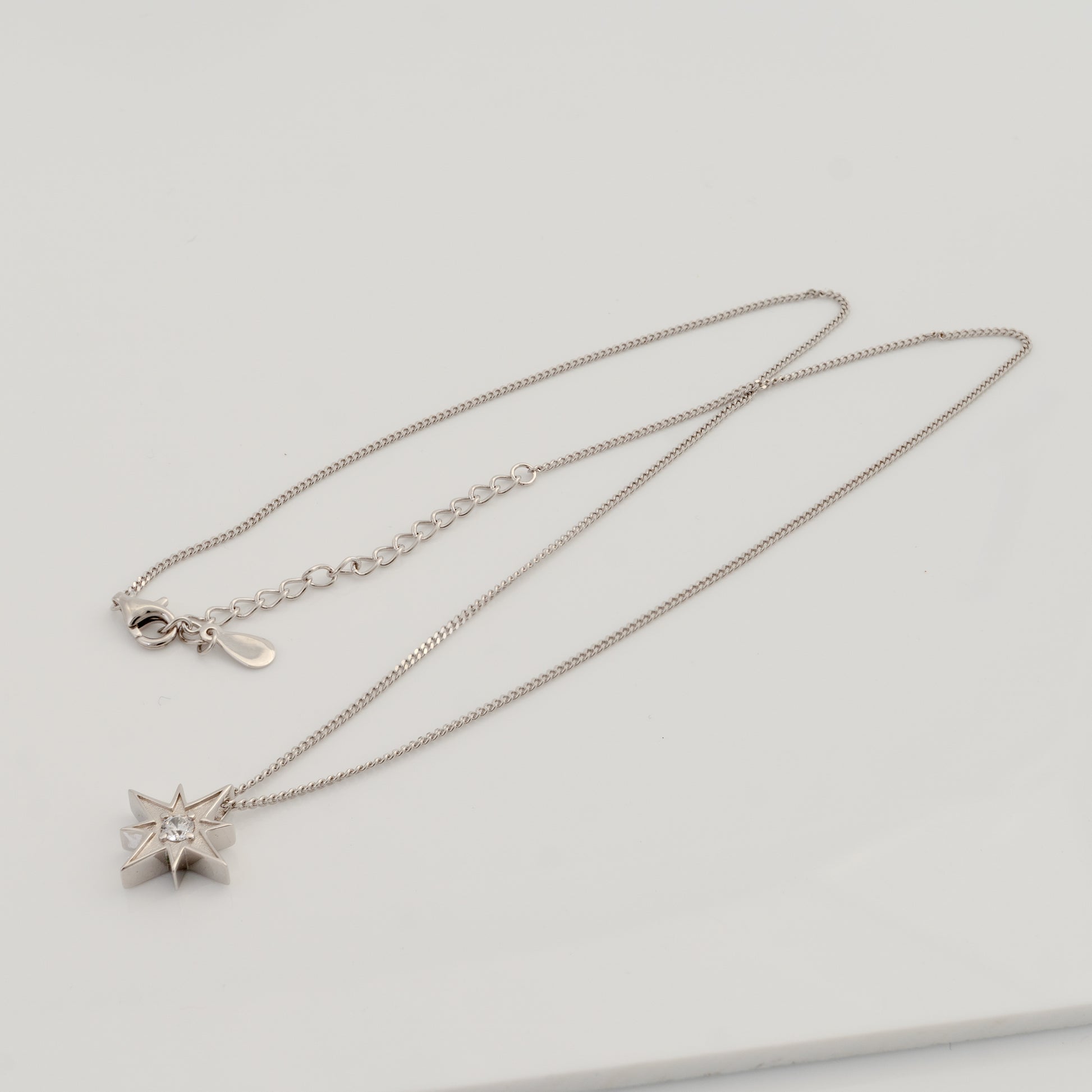 Sterling silver North Star necklace with chain laid flat