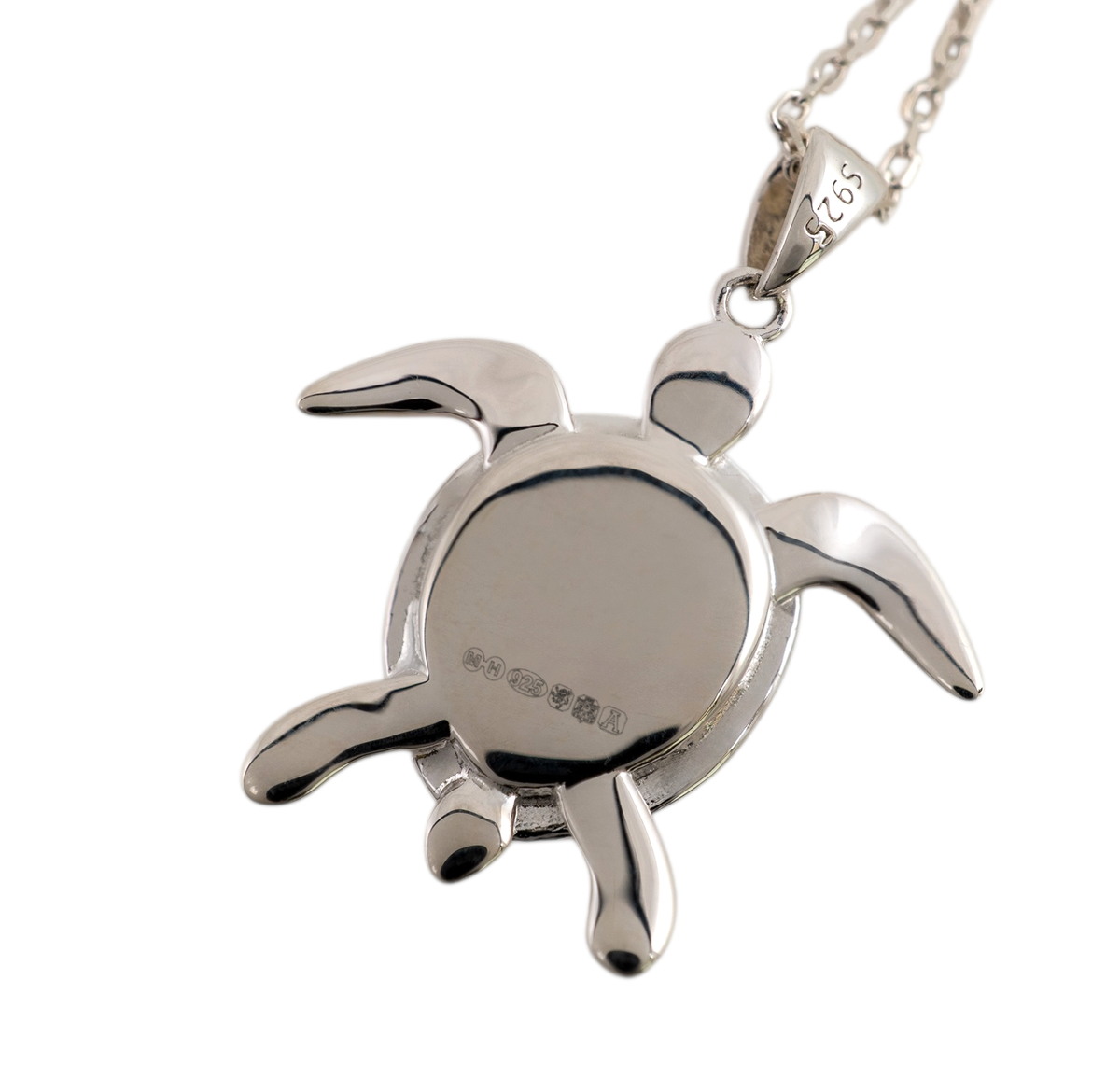 Smooth polished reverse of a sterling silver sea turtle pendant, showing hallmarks and a 925 mark on the bail