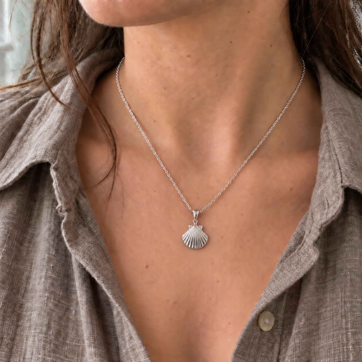 Model wearing a sterling silver scallop shell necklace