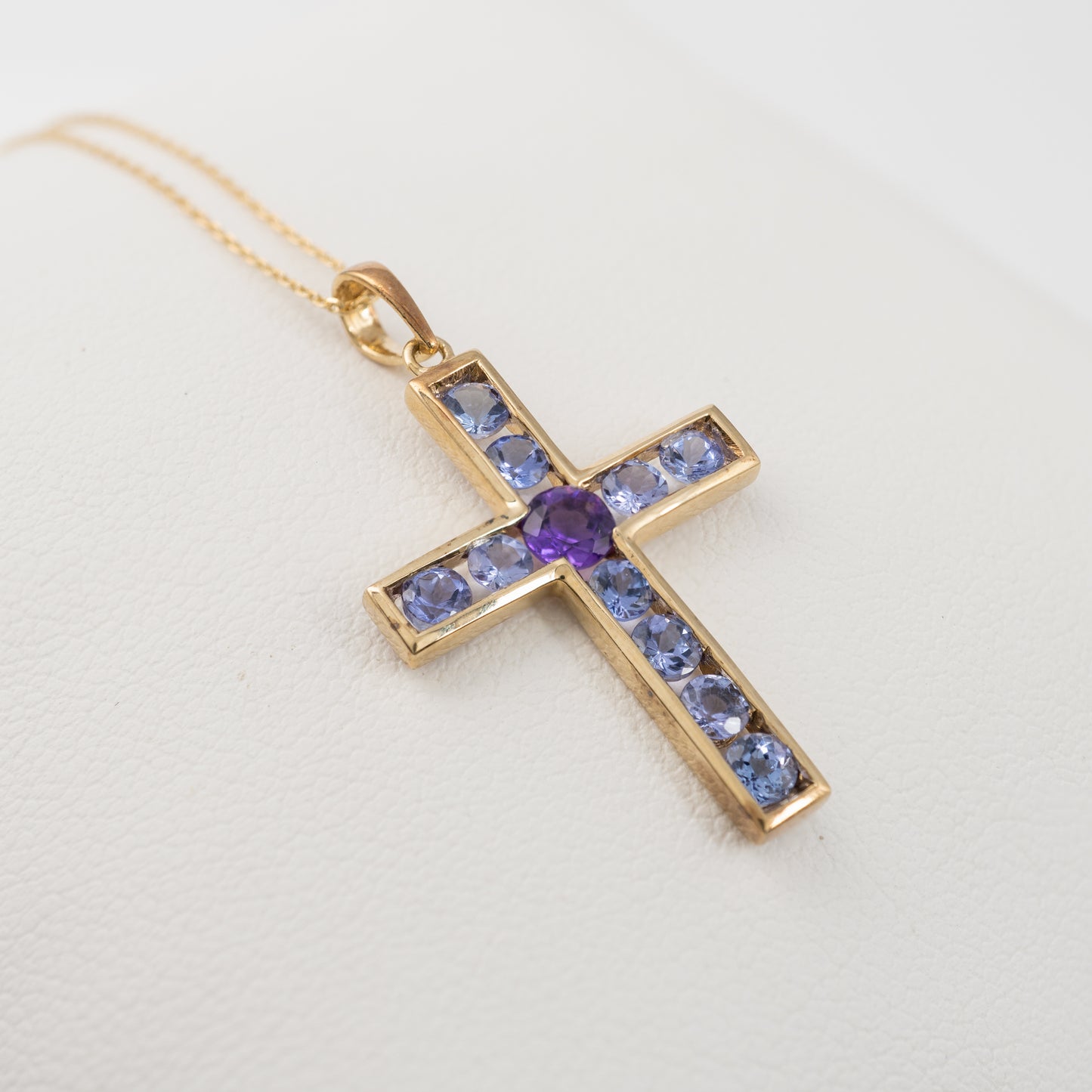 9ct gold crucifix Pendant close up of tension set gemstones