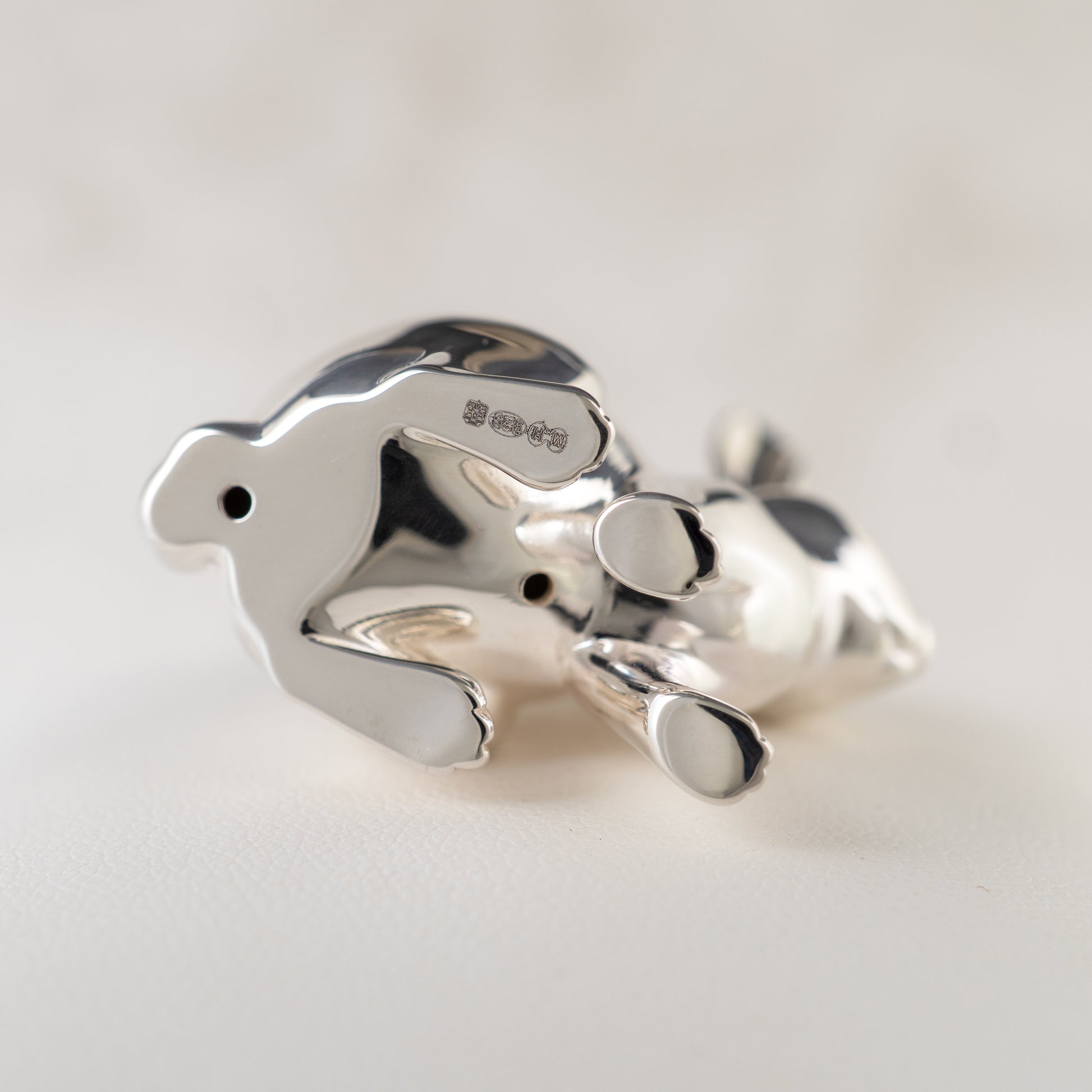 Sterling silver rabbit figurine underside showing Edinburgh hallmarks and hollow-cast vent holes
