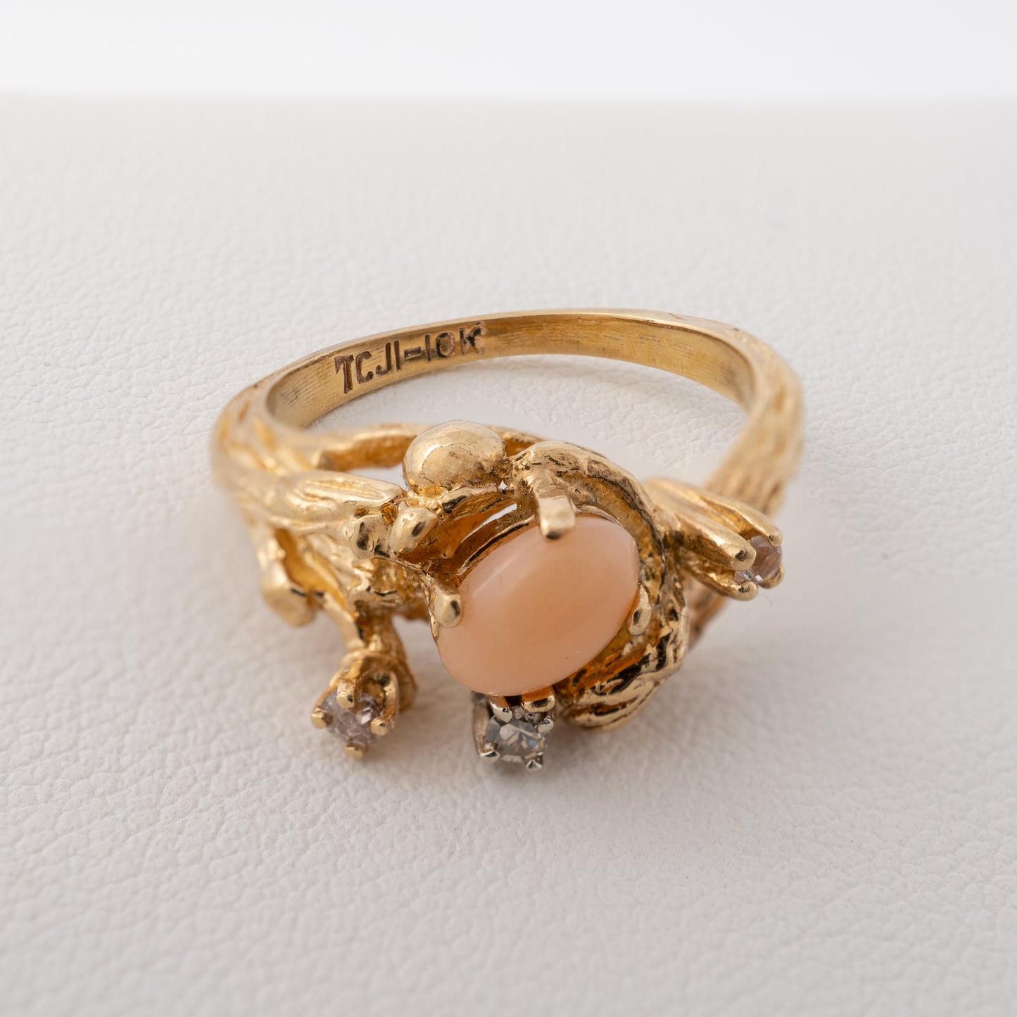 Close-up of hallmark inside vintage 10k gold coral ring with tree bark texture