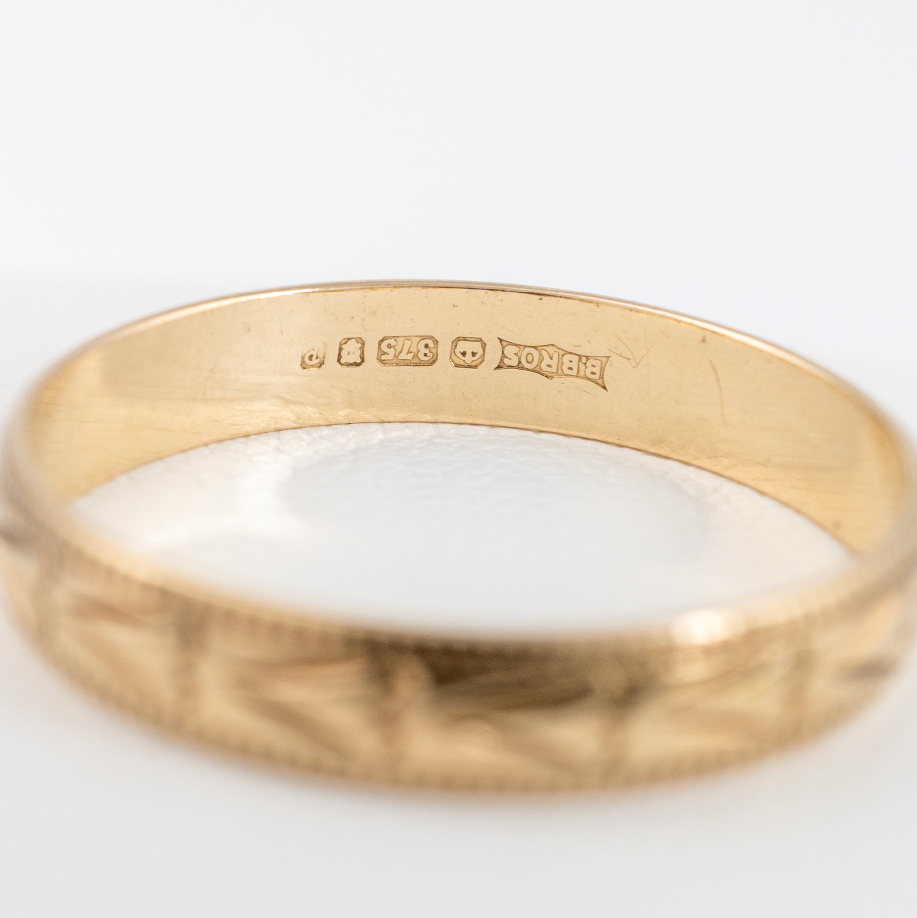 gold band with vintage assay hallmarks