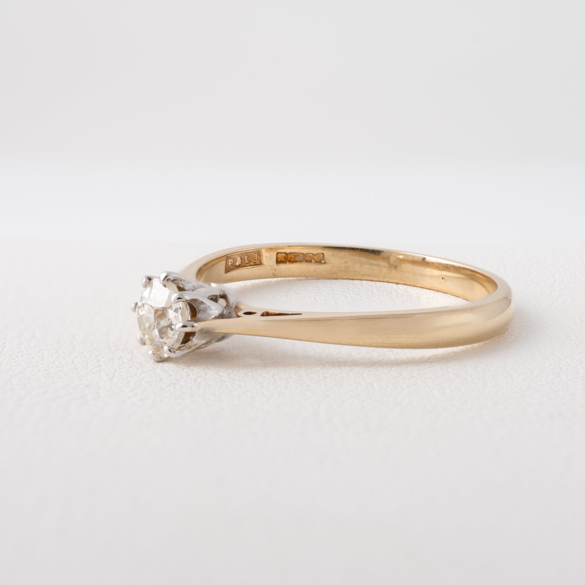 Side view of old cut diamond ring showing daylight shoulders and hallmarks