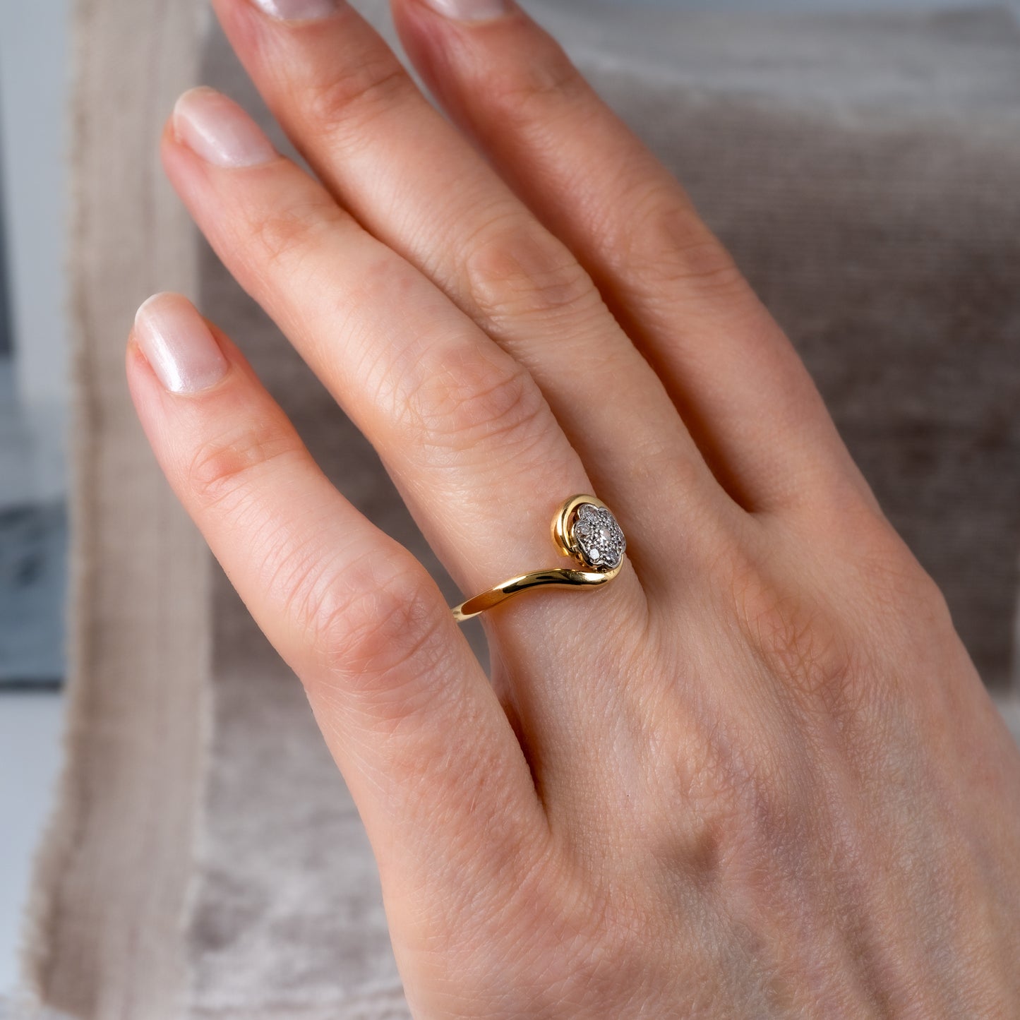 vintage diamond flower ring woman hand side view