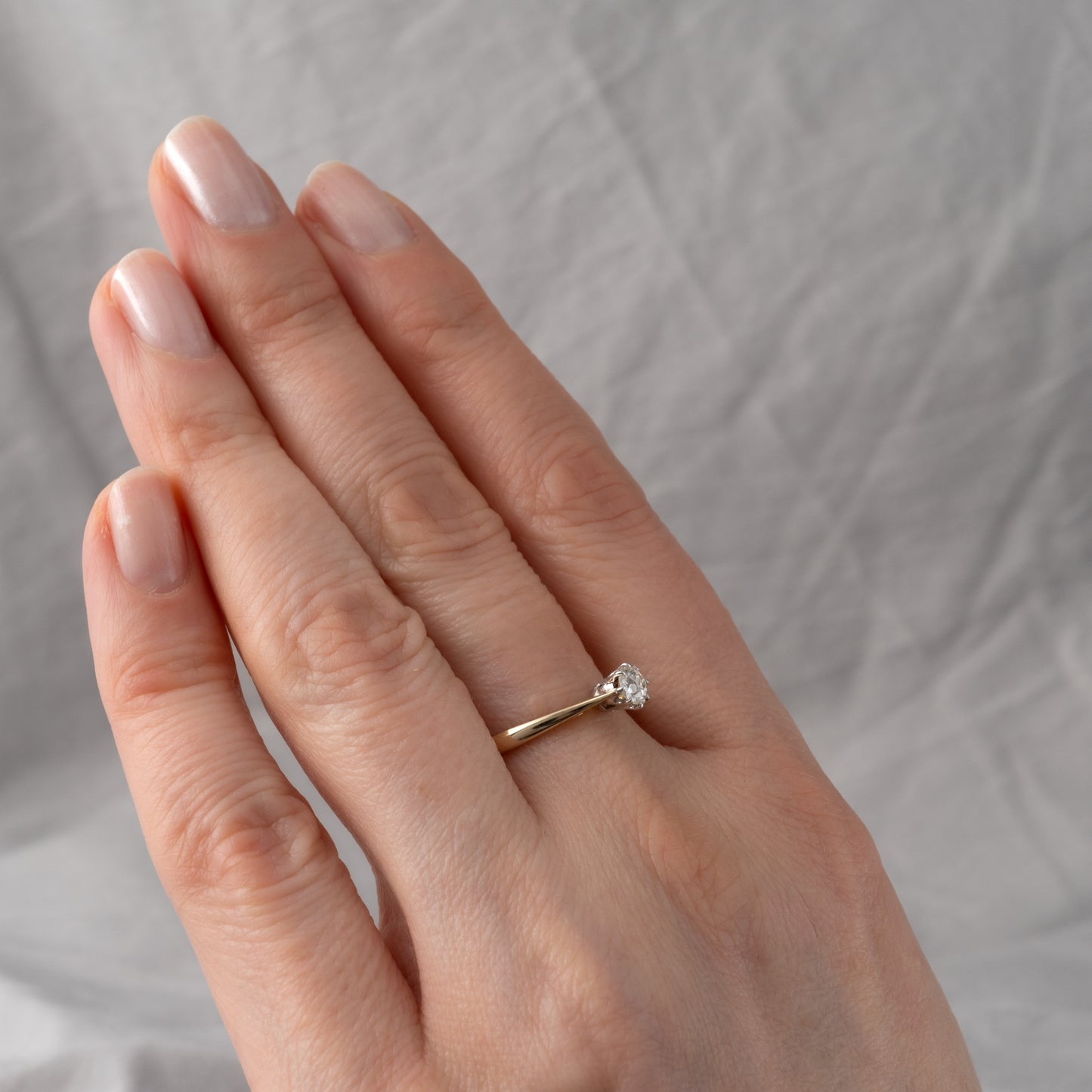 vintage old cut diamond engagement ring on womans hand showing height off the finger