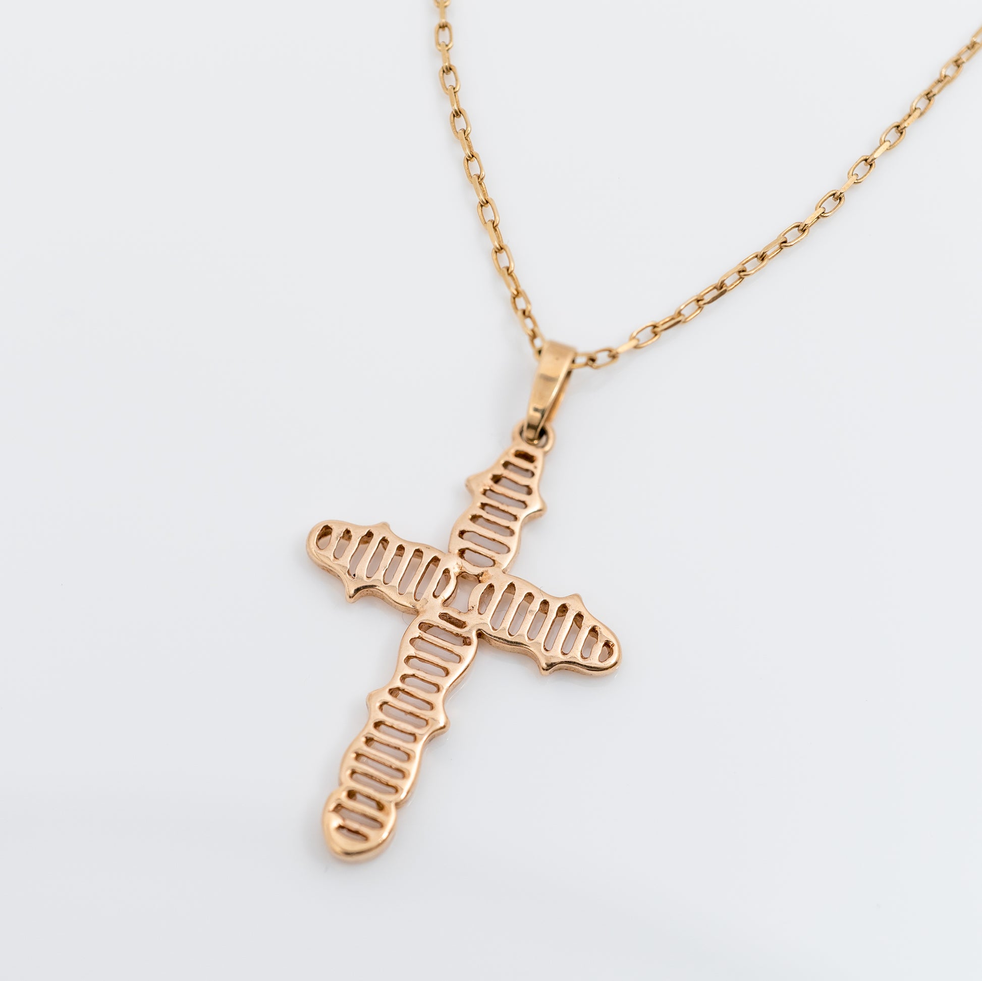 Top view of 9ct gold crucifix necklace with hallmarks on bail