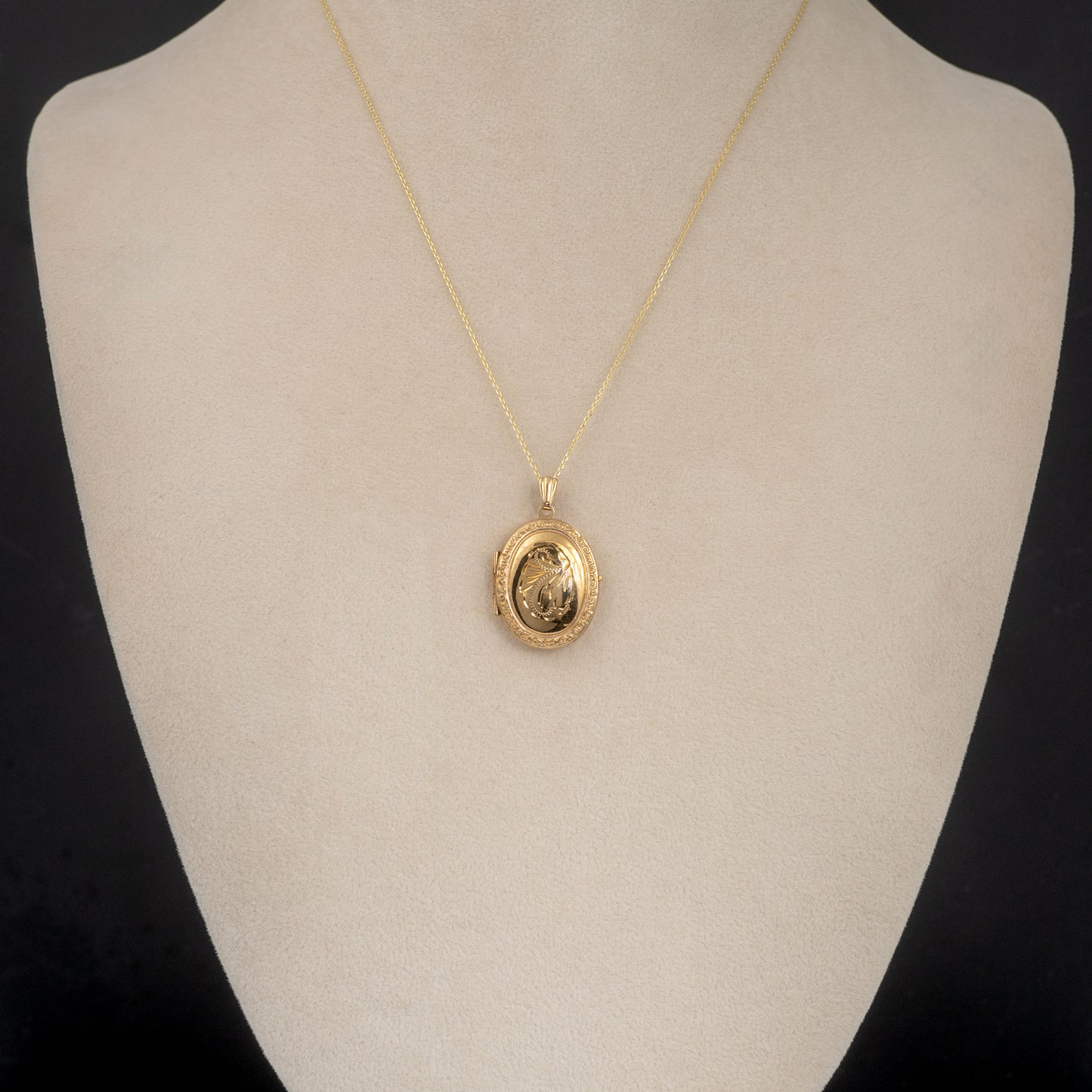 oval 9ct gold locket displayed on bust