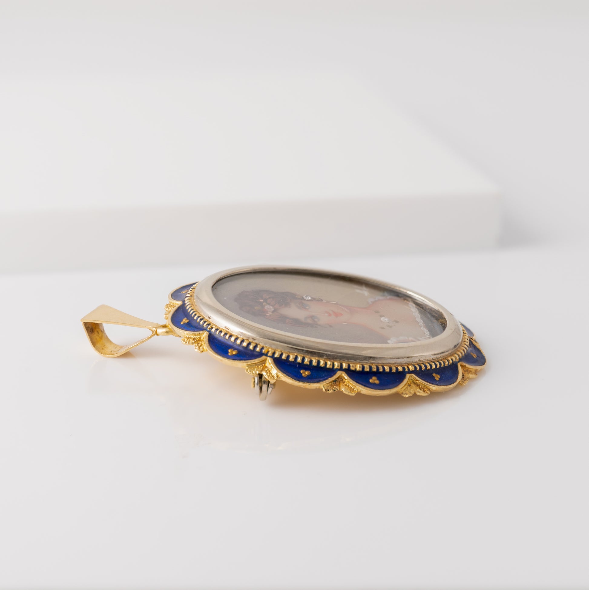 Detail of guilloché enamel and beadwork on vintage gold picture pendant
