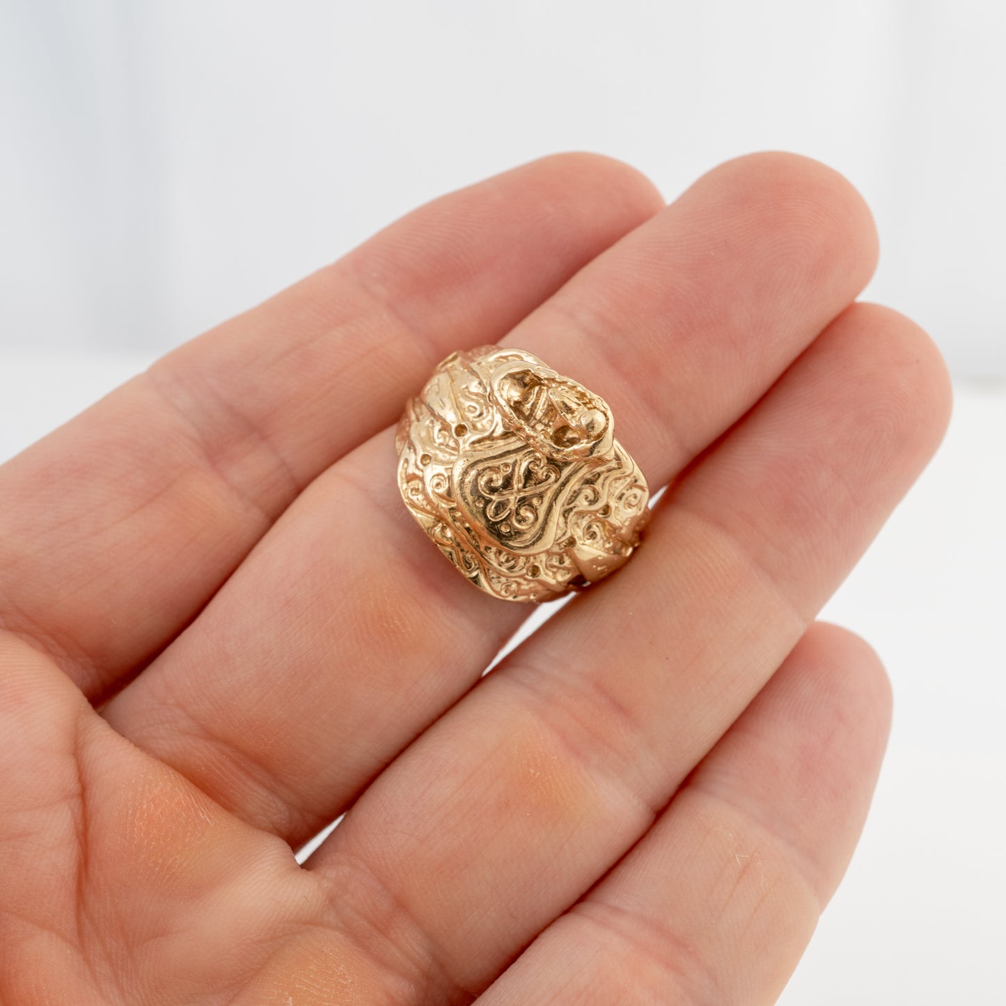 Vintage men's 9ct gold saddle ring shown on hand to illustrate its size, fit and substantial design.