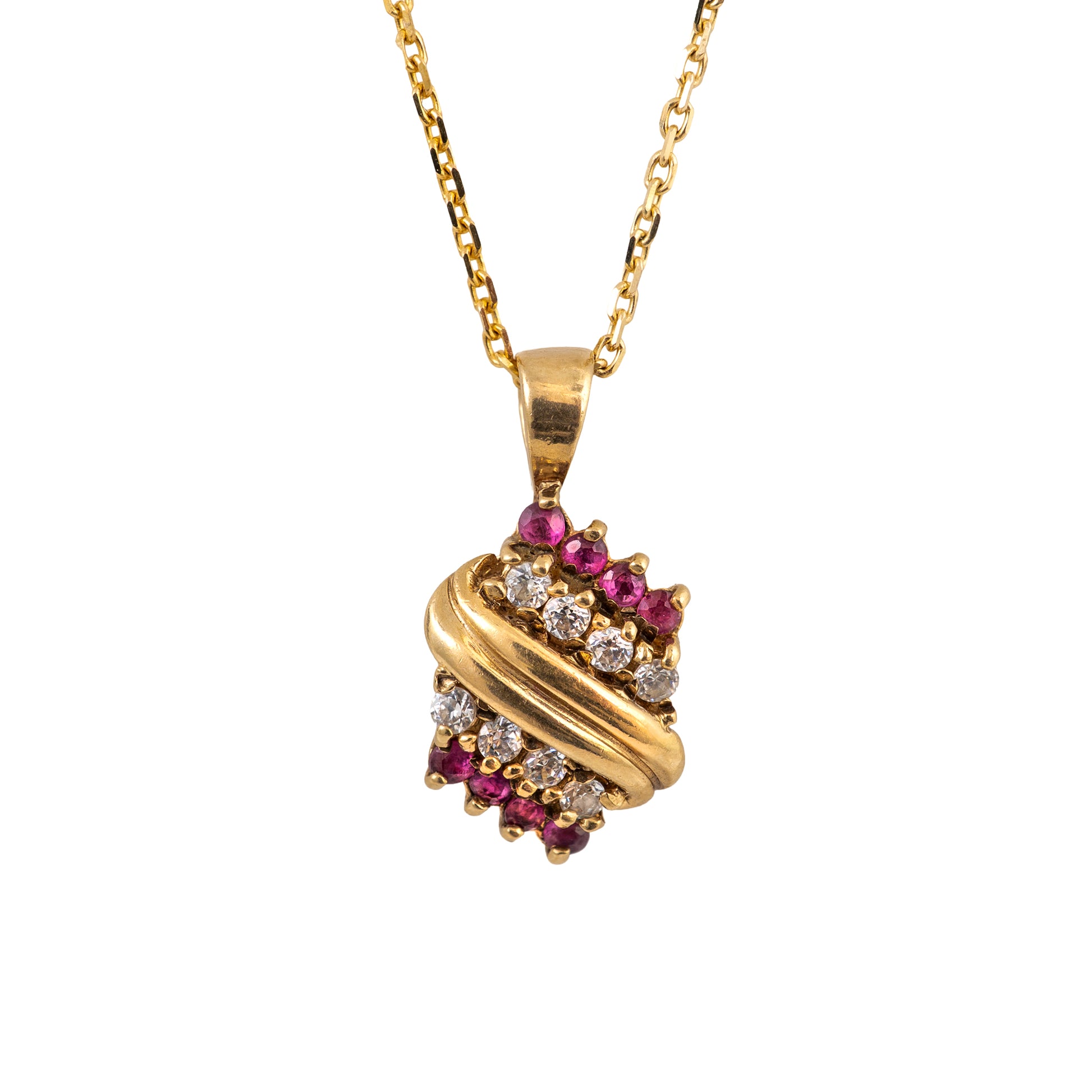 A gold pendant necklace featuring a twisted wrap design adorned with small pinkish-red gemstones and clear round stones, suspended from a gold chain against a plain white background.