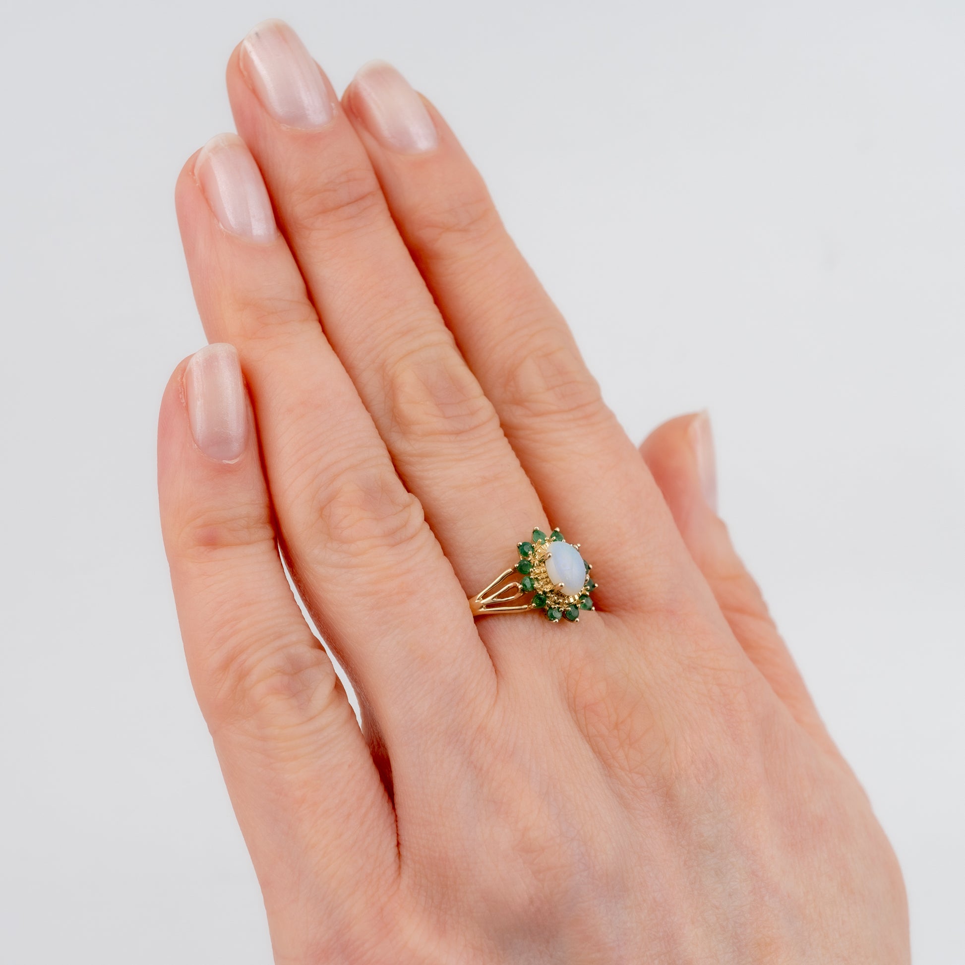 opal ring woman hand green emeralds floral design