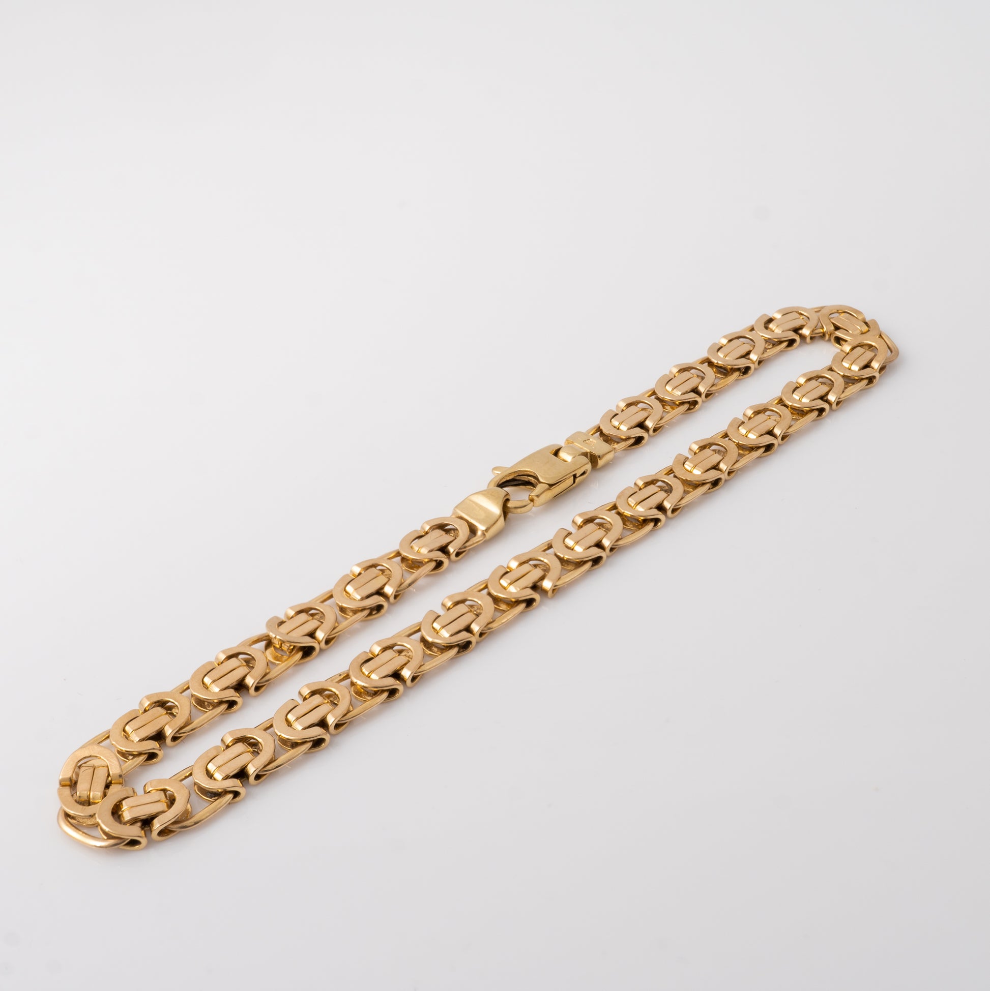 Women's gold bracelet showing intricate Byzantine links