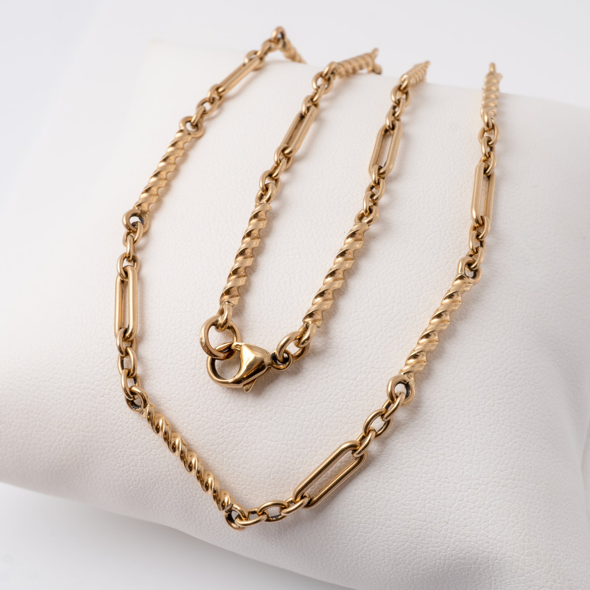 Close-up of vintage 9ct gold chain necklace with mixed link design on white background, Hunters Fine Jewellery