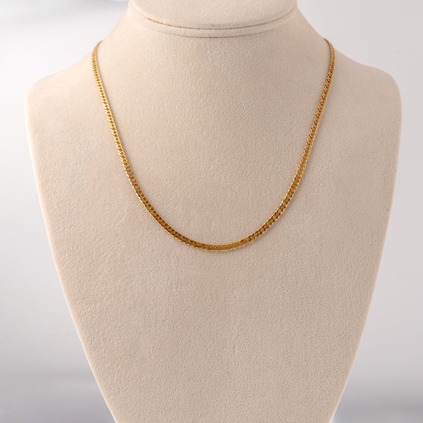 9ct gold curb chain necklace displayed on a jewelry bust for scale and elegance