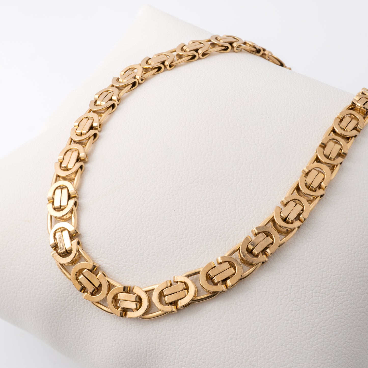 Women's Byzantine gold bracelet on display pillow