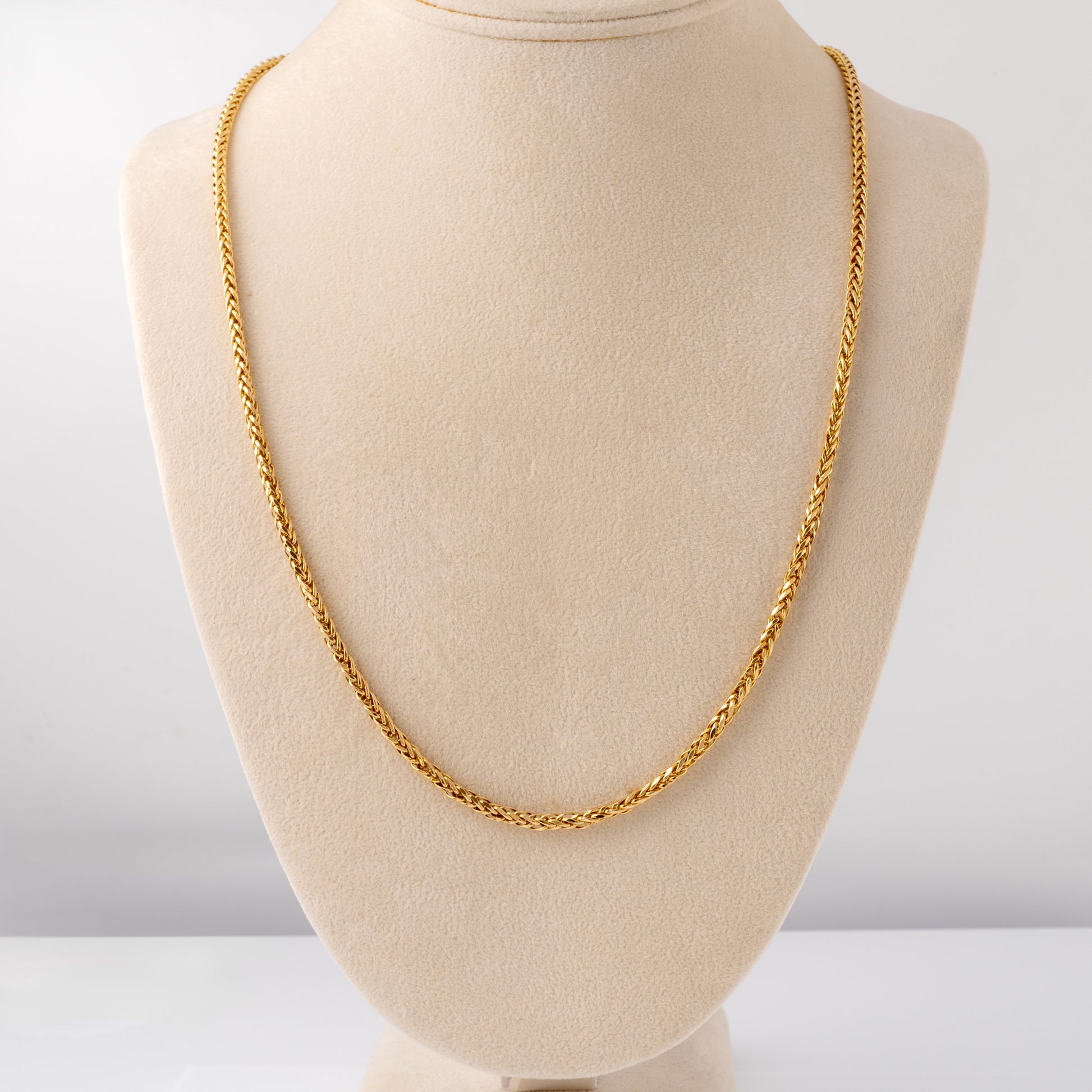 9ct gold spiga chain necklace for women displayed on a jewellery bust, 28 inches long