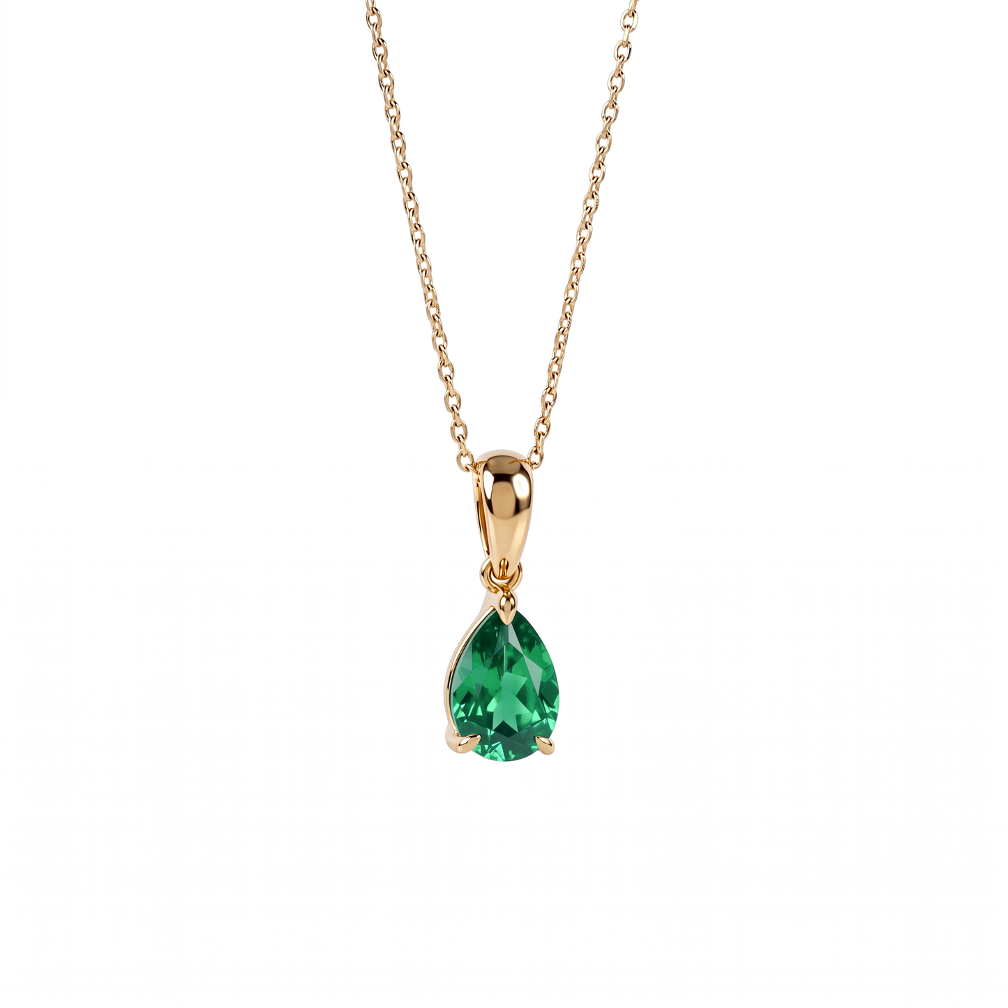 A gold pendant necklace featuring a teardrop-shaped lab emerald gemstone, suspended from a delicate gold chain against a plain white background.