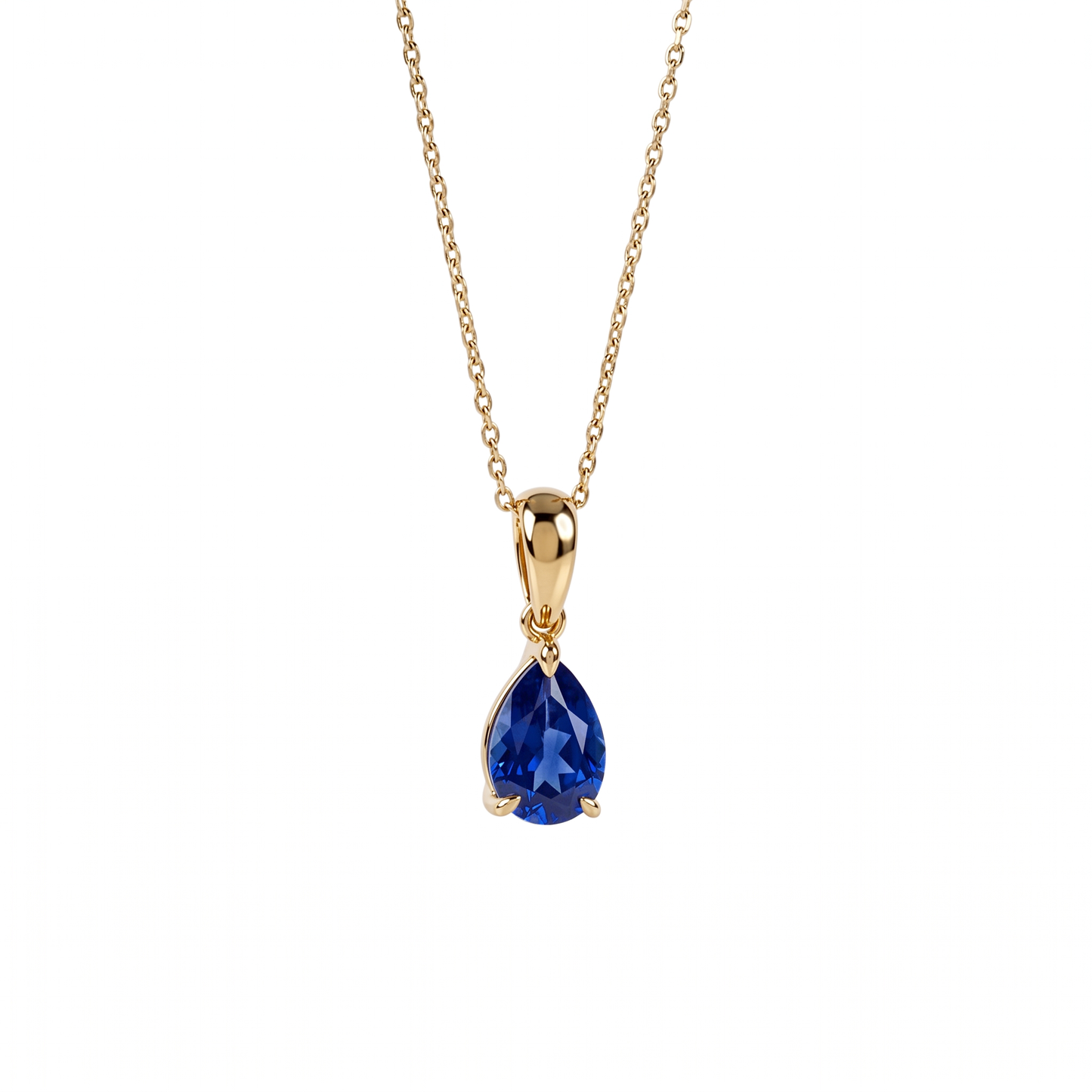 A gold chain necklace with a teardrop-shaped blue sapphire gemstone pendant, shown against a plain white background.