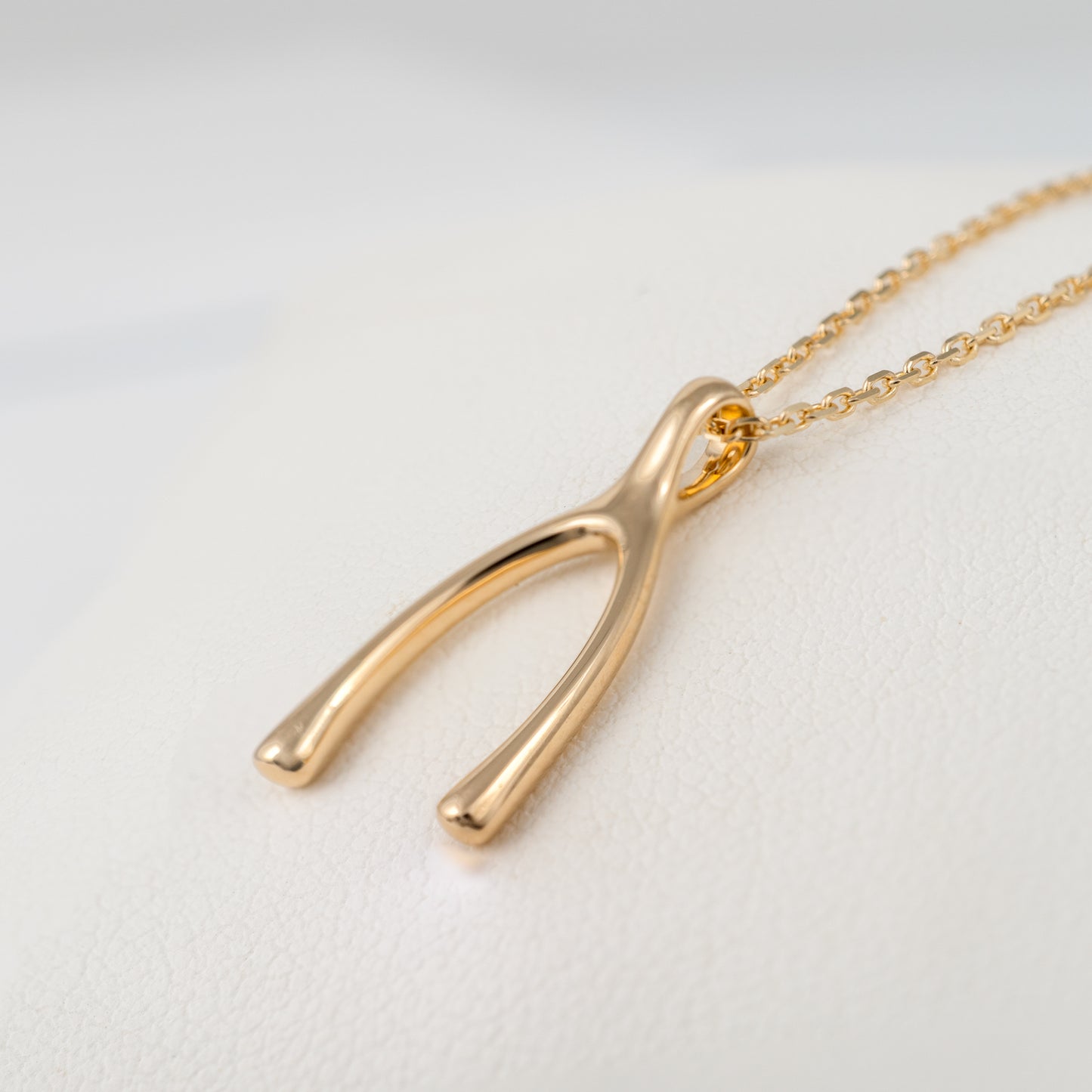 yellow gold wishbone necklace pendant side view